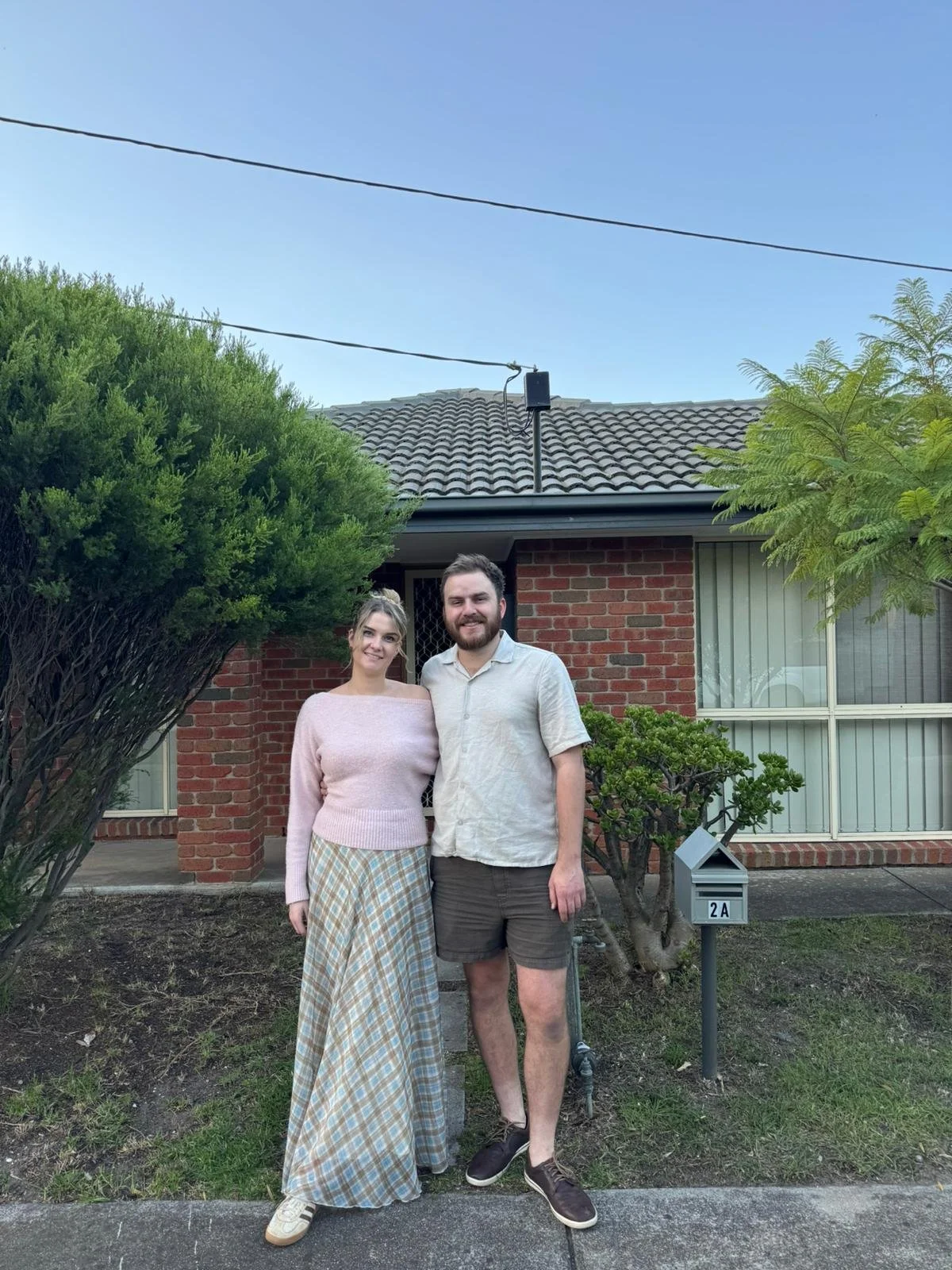 Young first home buyer couple in Altona, Melbourne in front of new home