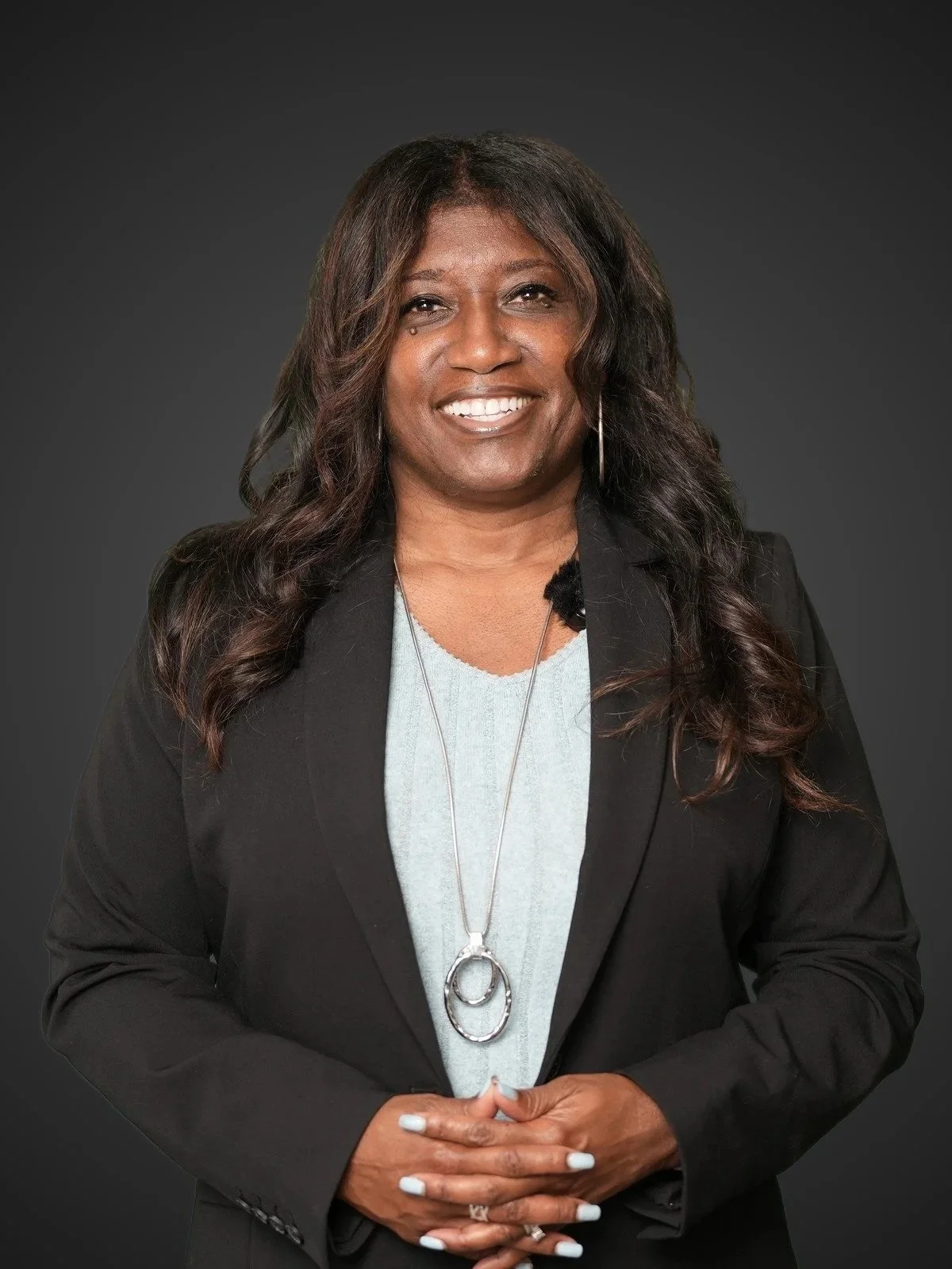 Professional headshot of a pretty black businesswoman