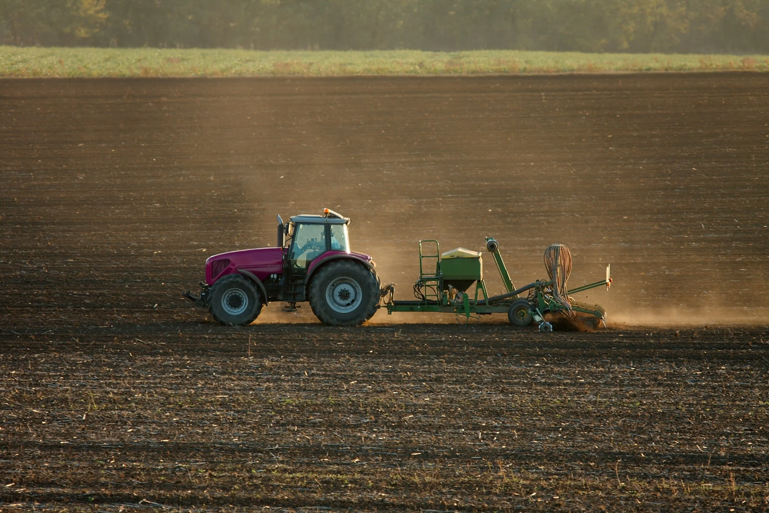 Tractor ploughing & sowing in a prepared field