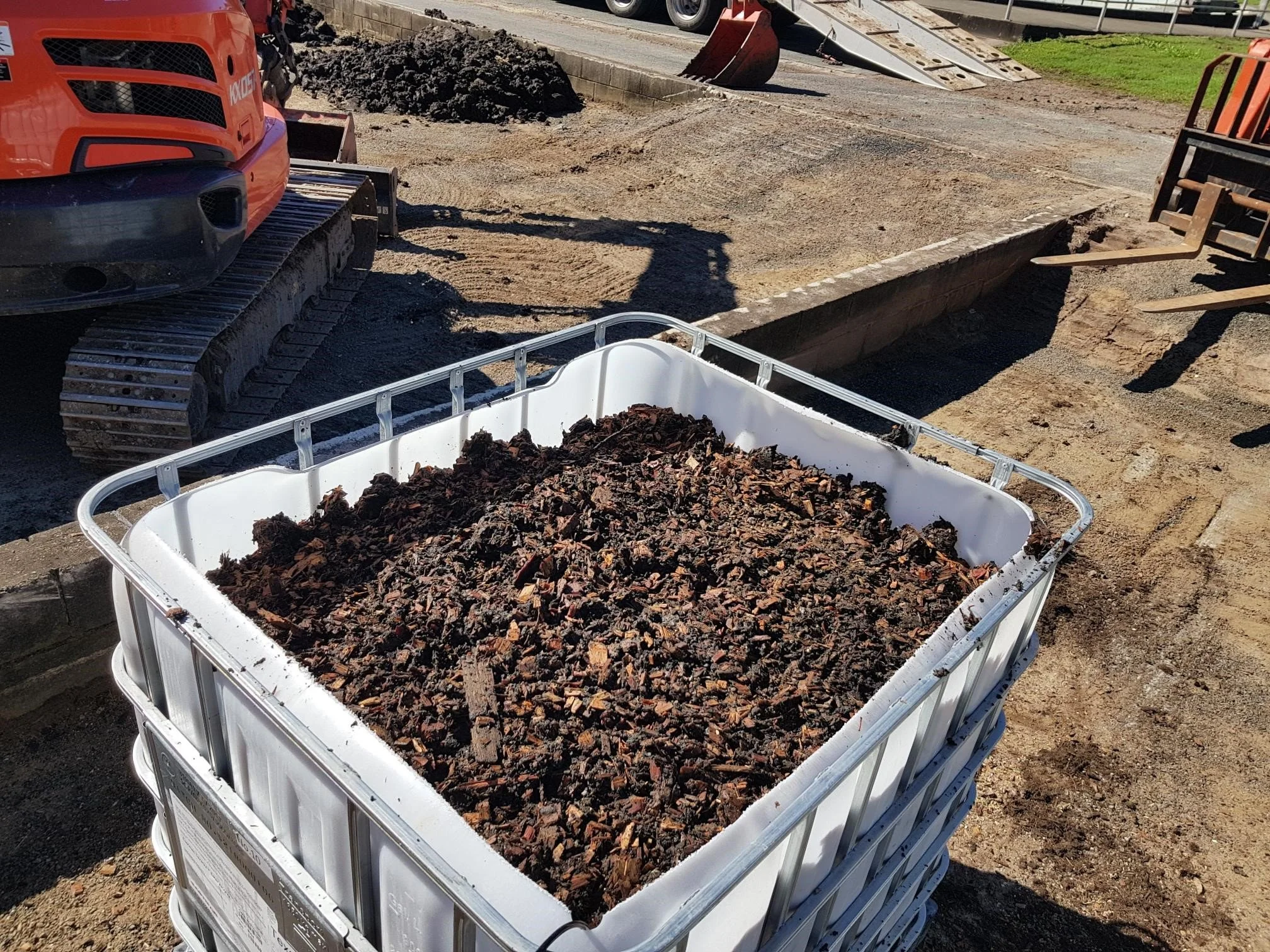 Blended biosolids compost being prepared for application