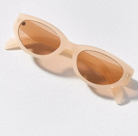 Off-white sunglasses with brown lenses styled on a textured surface, representing timeless yet modern fashion accessories.