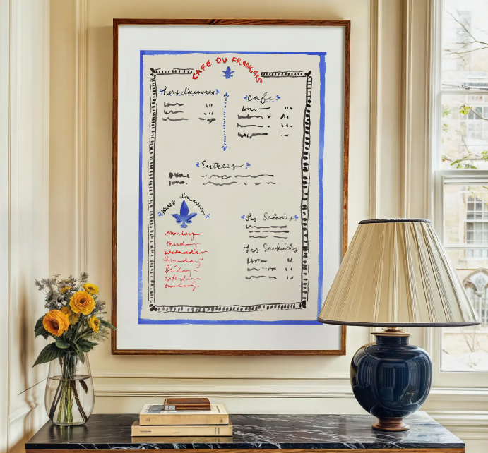 Framed handwritten menu styled above a marble table with flowers and lamp, representing elegant dining and modern etiquette.