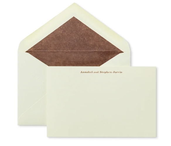 Cream envelope with brown lining and personalized stationery, styled for modern etiquette and handwritten notes.