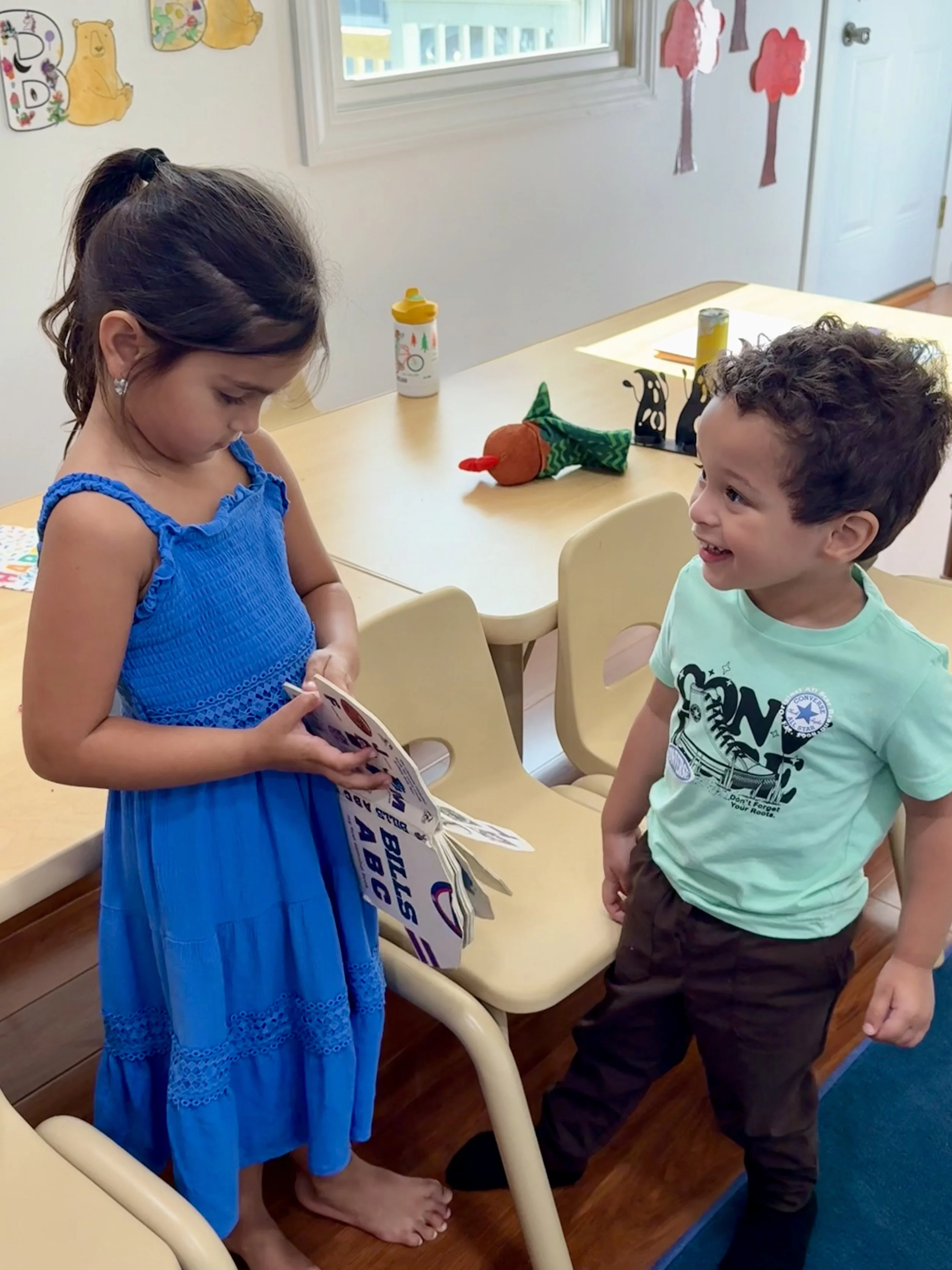 Two preschoolers together in the Kids Come First classroom