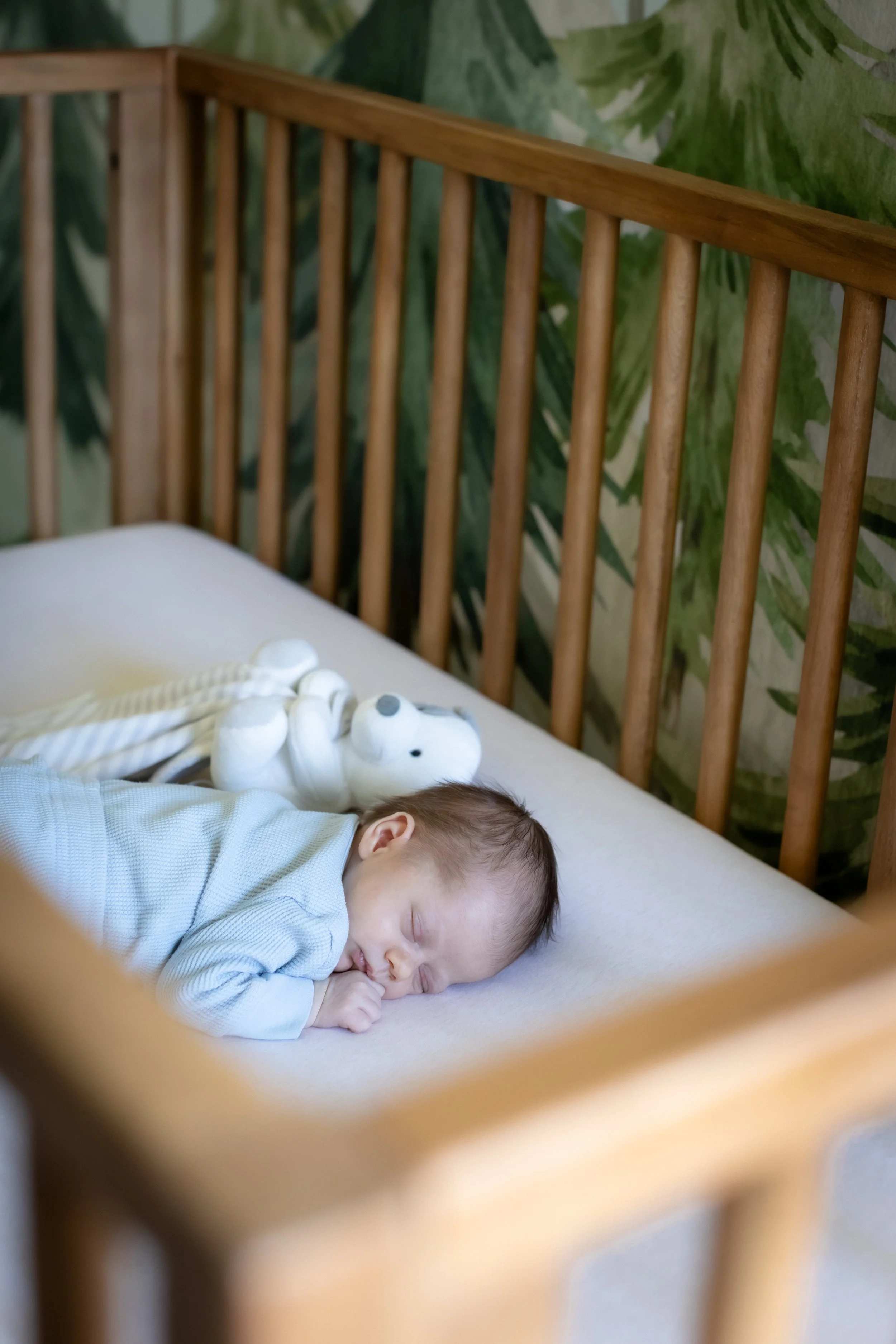 Newborn sleeping in a crib during an in-home newborn session in Conejo Valley