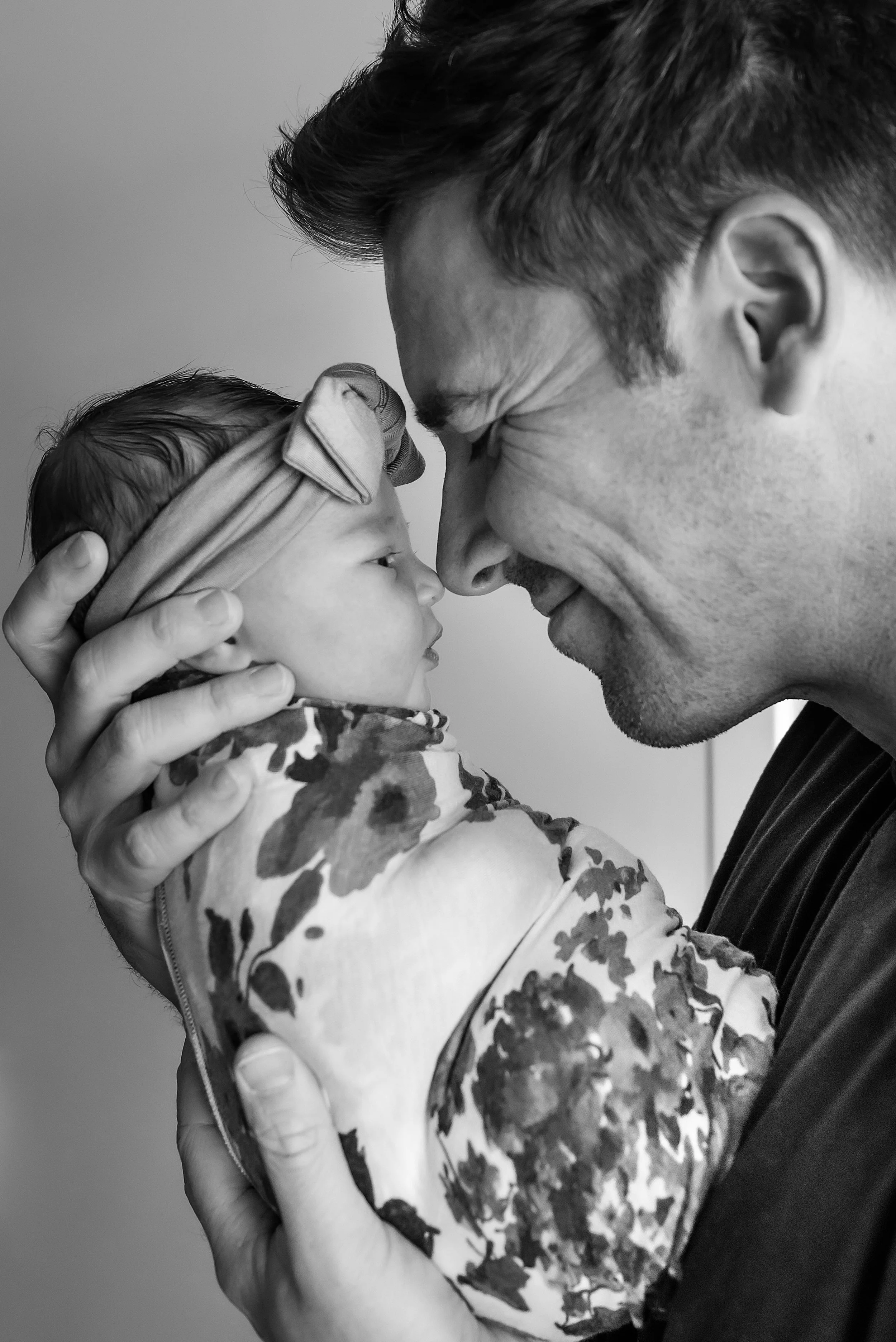 Father holding his newborn daughter during an in-home newborn session in Thousand Oaks
