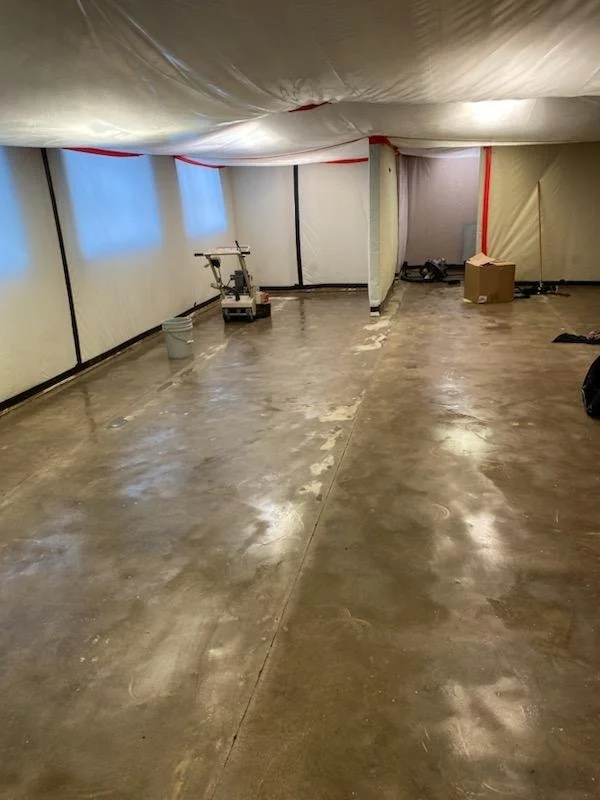 Underground basement under construction with exposed flooring, construction equipment, and plastic sheeting on the ceiling. Farese & Co. Strategic Commercial Space Strategy for Property Owners and Lessees West Hartford Coworking Windsor Worx East Har