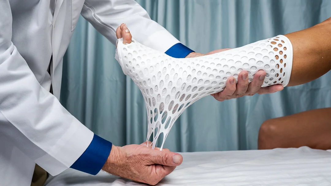 Medical professional applying Derma Compress to a patient's leg in a clinical setting.