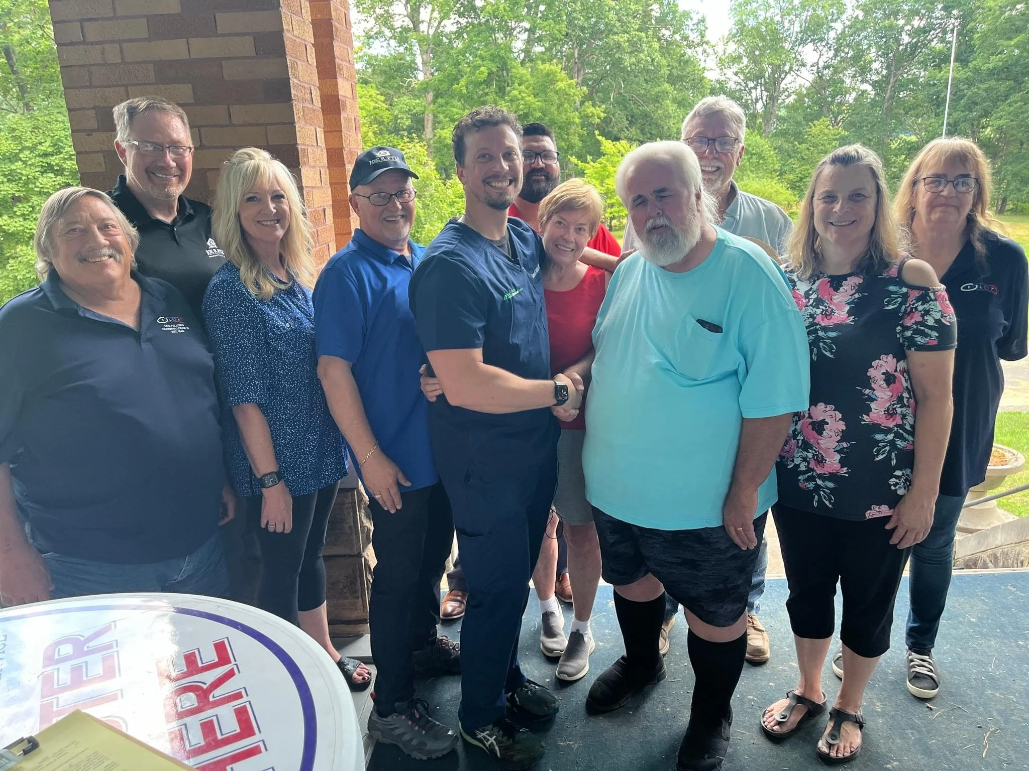 shaking hands at the signing of the papers