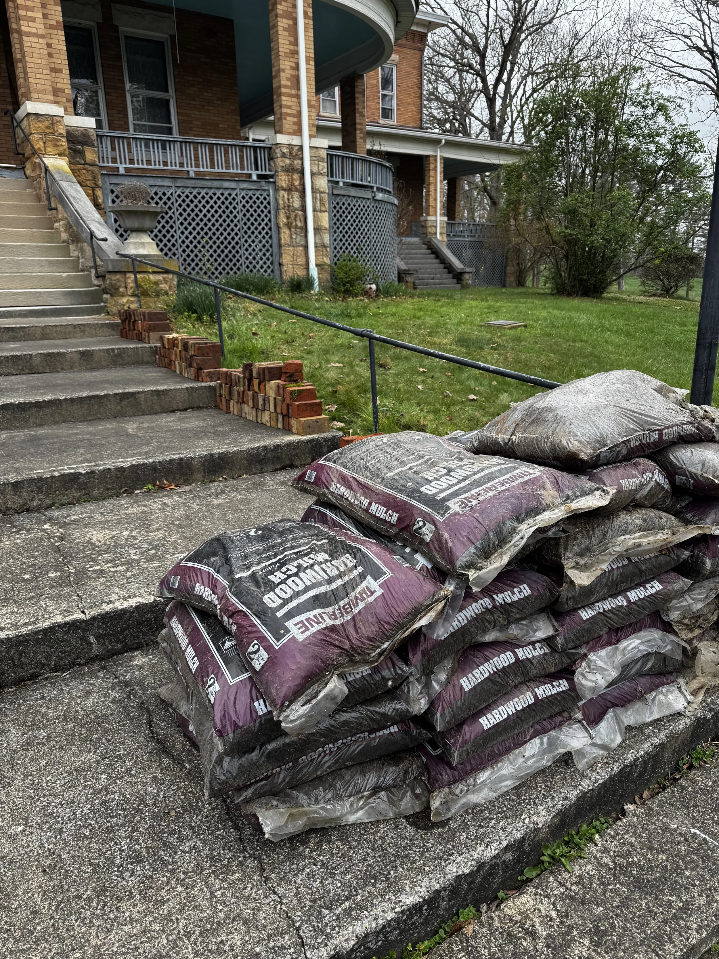 mulch and bricks on the front steps of the oddfellow manor