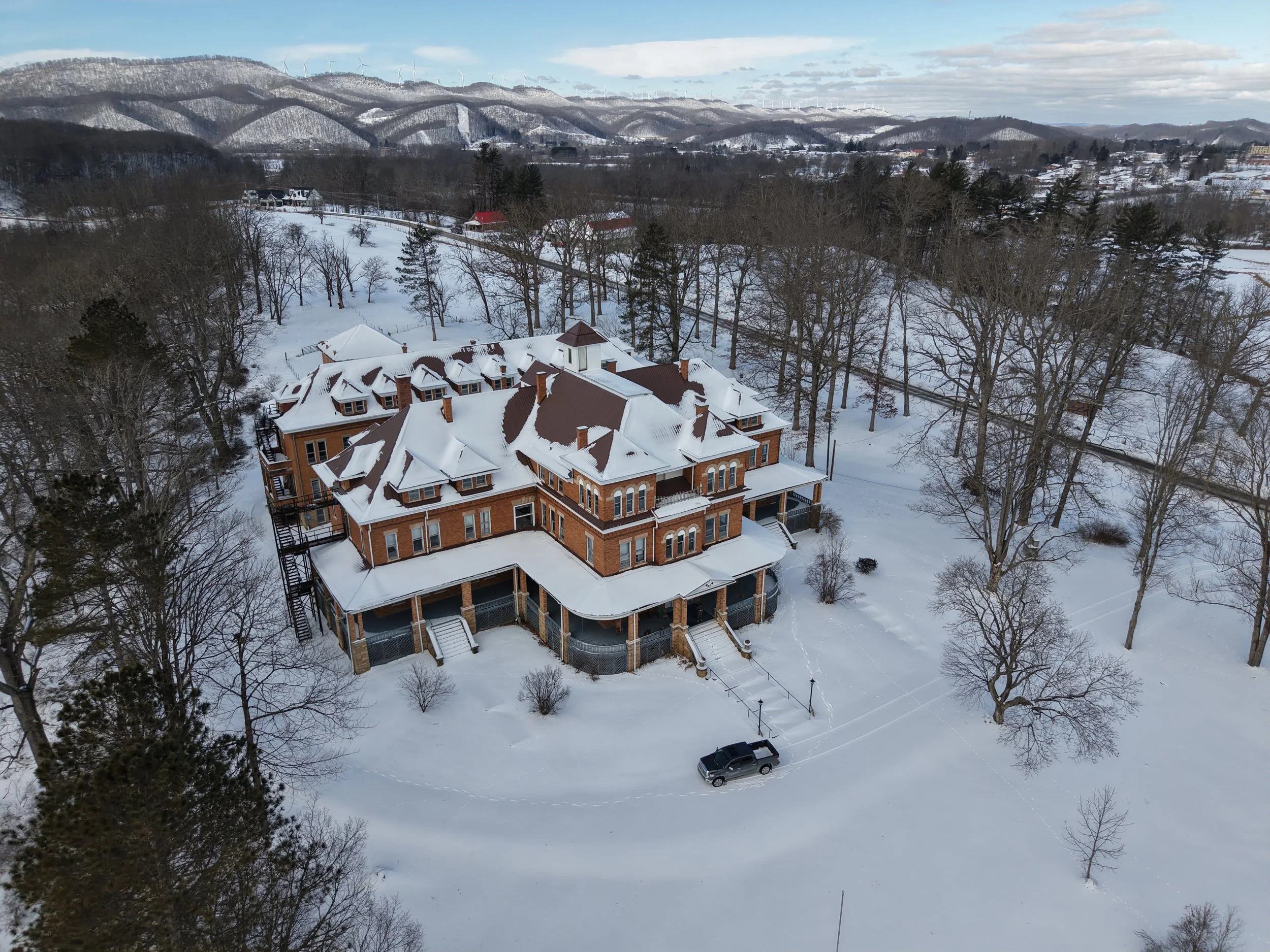 A snowy drone photo of the oddfellow manor of elkins wv