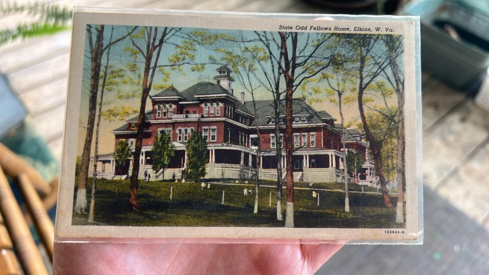A vintage postcard of a large, historic mansion called State Odd Fellows Home in Elkins, West Virginia, with trees and a lawn in the foreground.
