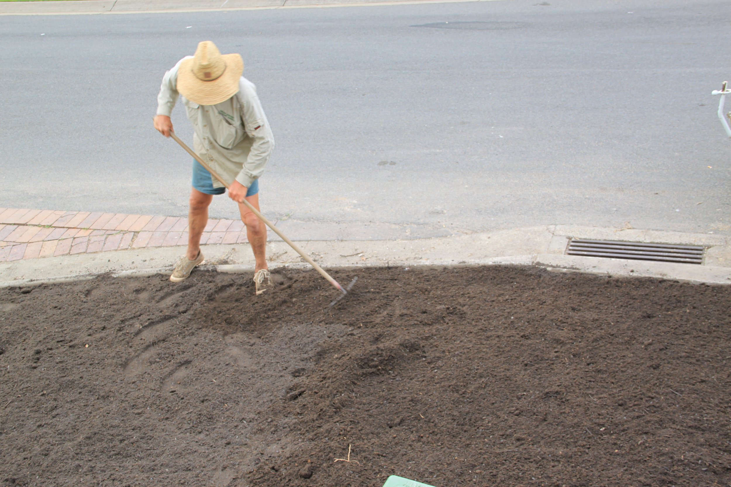 Preparing soil for turf and gardens using premium organic fertilizer.
