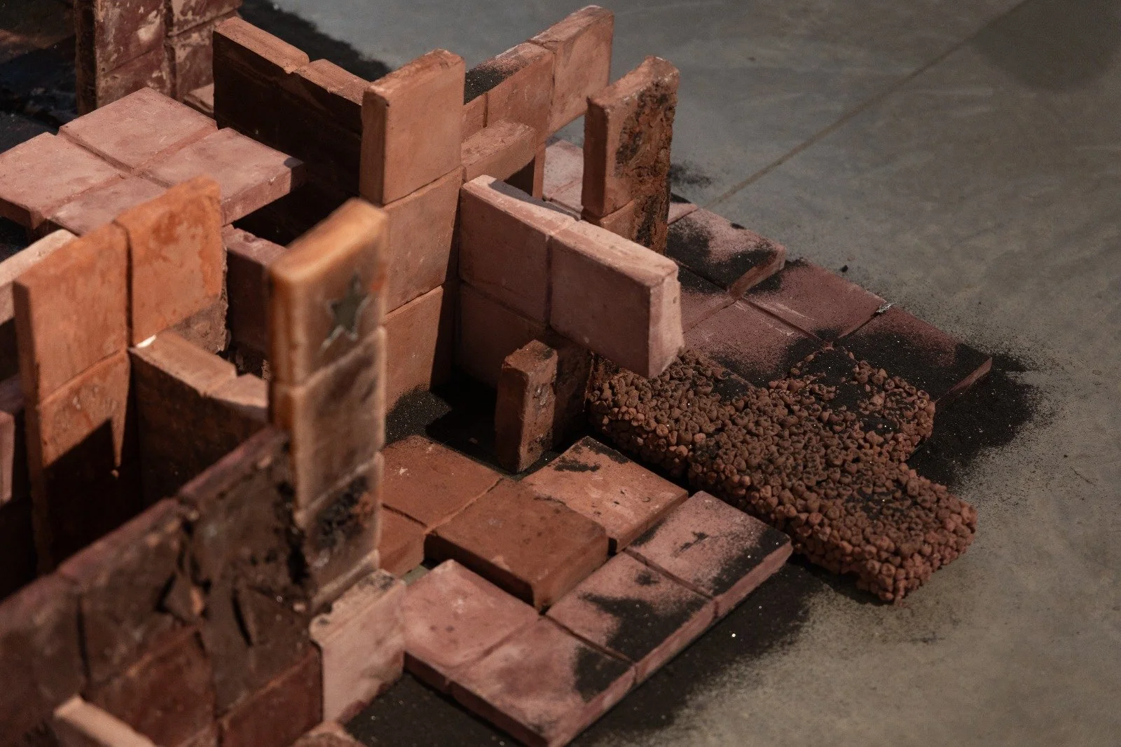 Zitz, Oil, Jolts, Soil, concrete, wax, glass, black sand, hair, and steel, 2025