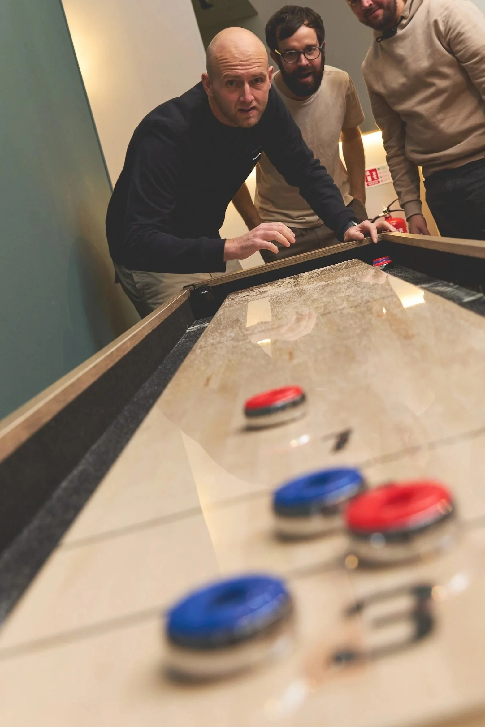 people playing shuffleboard