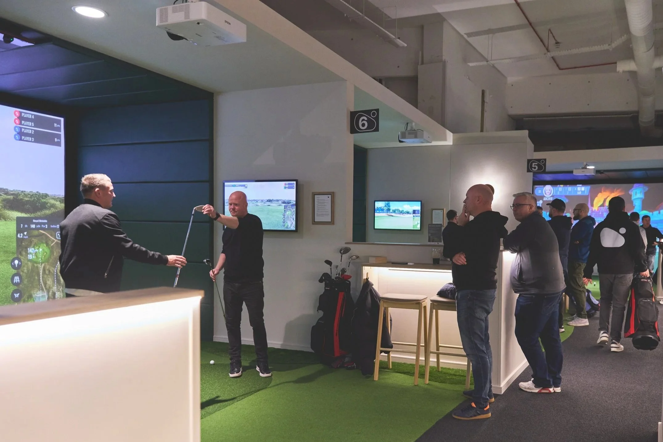 golfers playing indoor golf