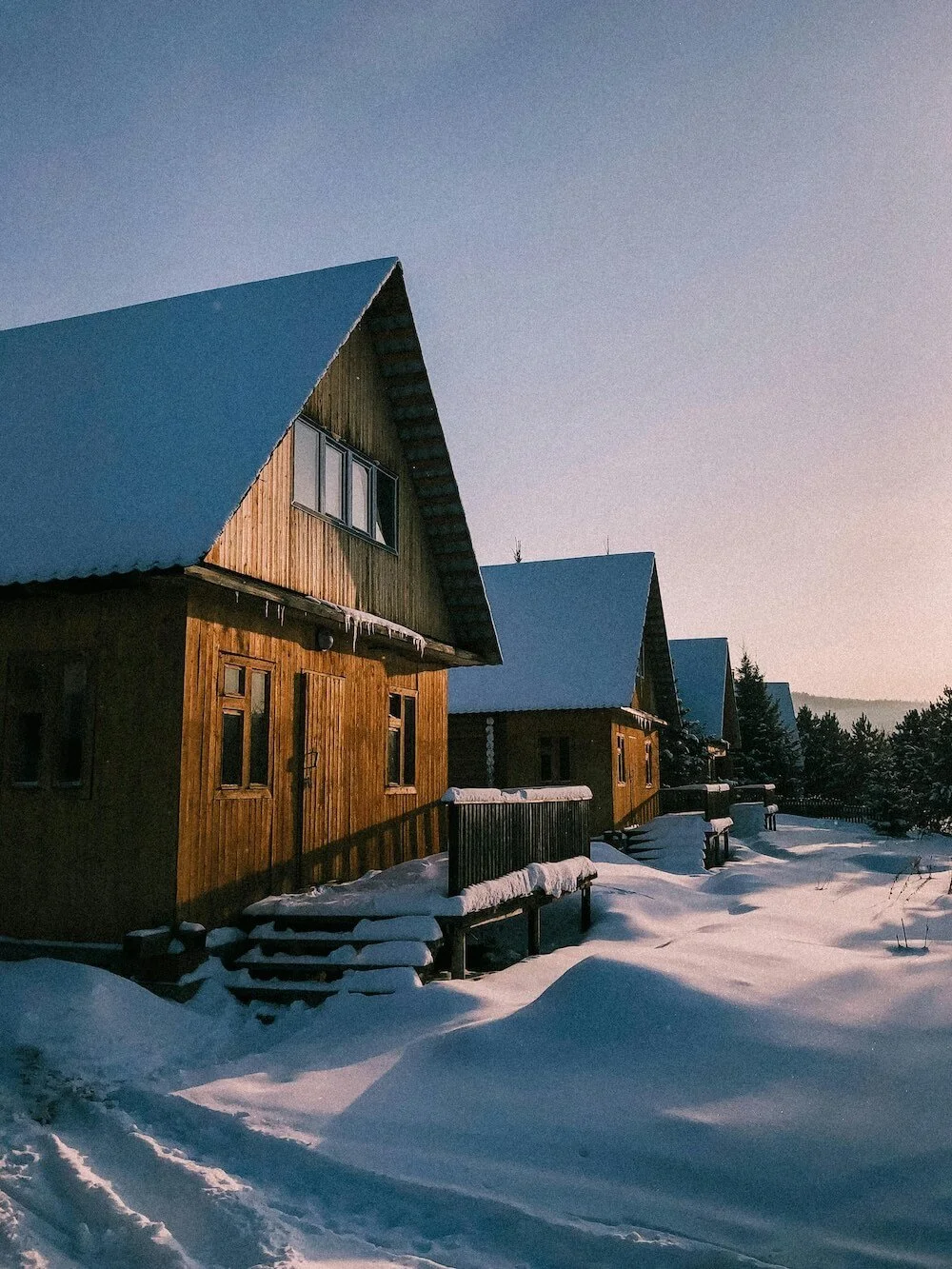 Vacation rental cabin in winter surrounded by snow-covered trees