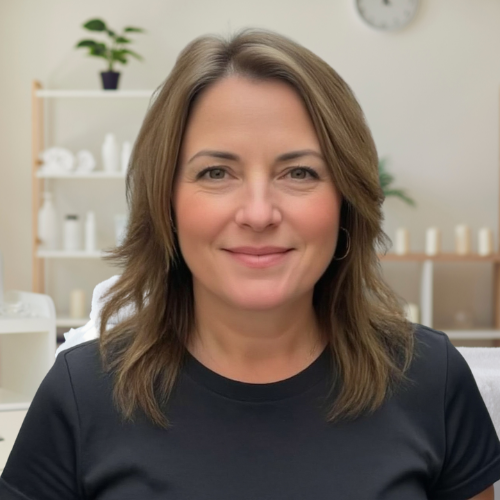 Woman smiling in a spa or wellness setting with shelves in the background