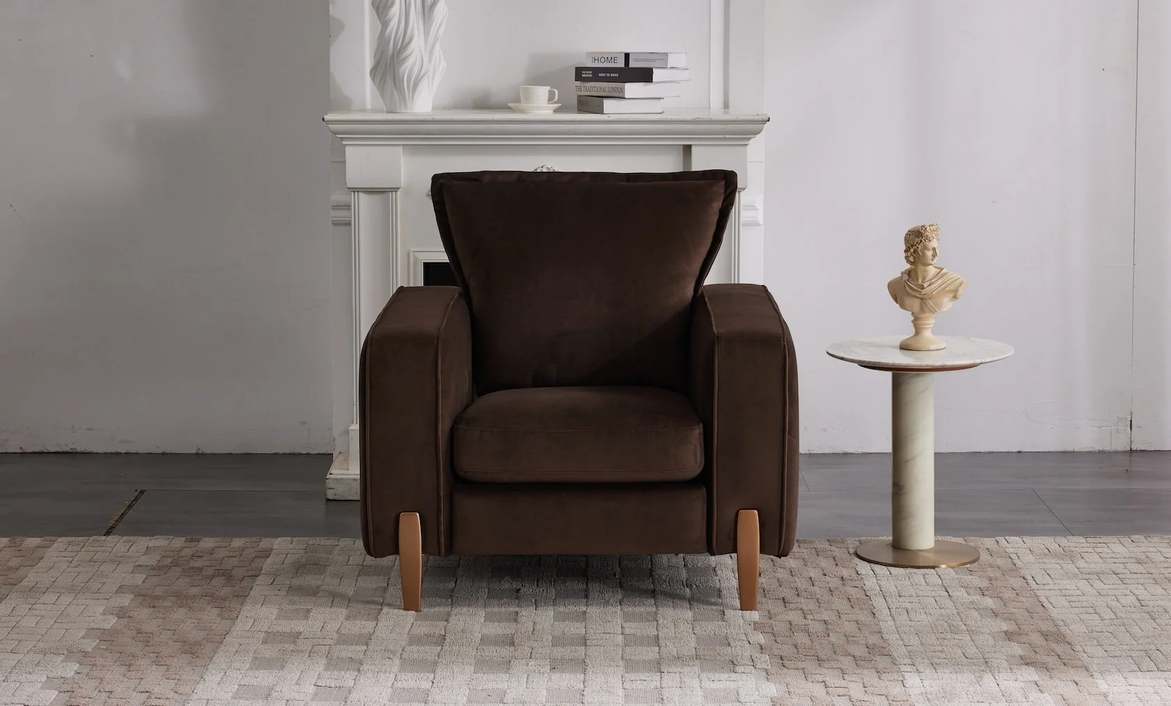 A brown armchair with wooden legs, flanked by a white fireplace mantel in the background and a small round marble-topped table holding a classical bust sculpture on the right. The room has white walls, gray hardwood floors, and a beige patterned rug.