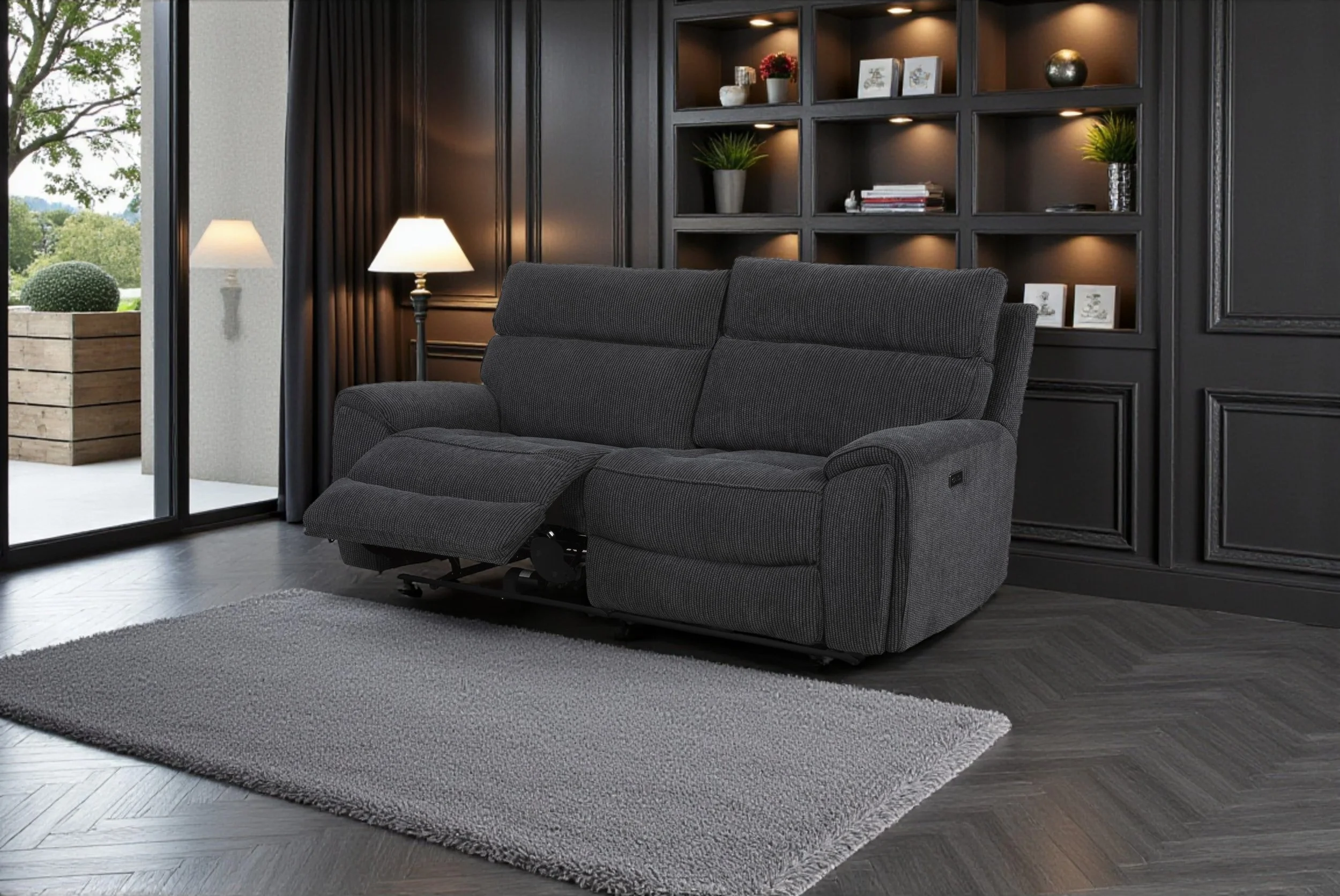 Living room with a gray sofa, wooden accent wall, arched doorways, a framed landscape painting, a floor lamp with a curved arm, and a beige area rug.