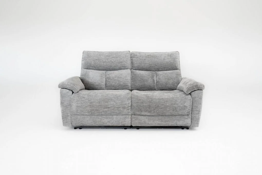 Gray upholstered loveseat with plush armrests in front of a white background.