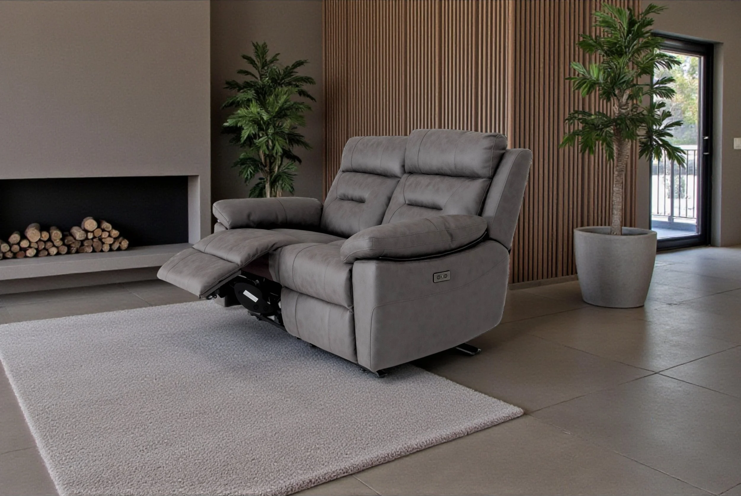 Gray leather loveseat with armrests on both sides, set against a plain white background.