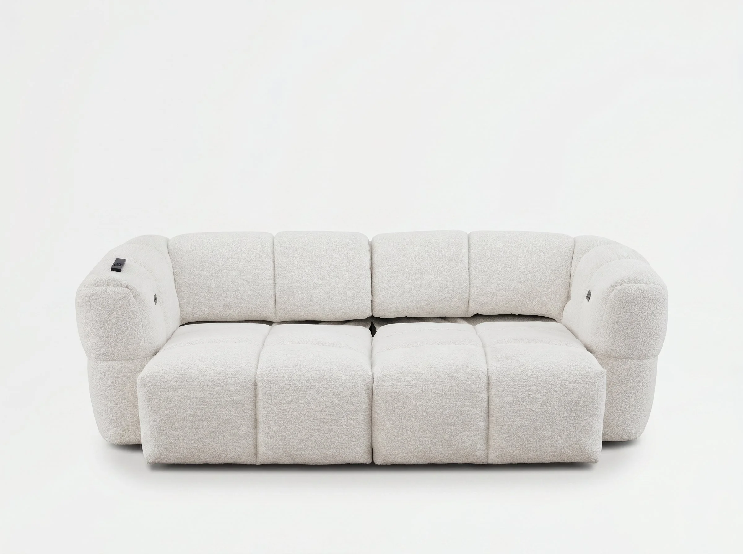 A white, plush, three-seater sofa with rounded armrests on a plain white background. There is a remote control on the left armrest.
