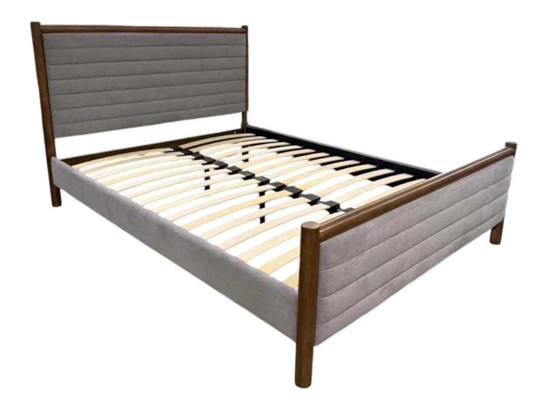 A modern upholstered bed frame with wooden legs, headboard, and side panels, without a mattress.