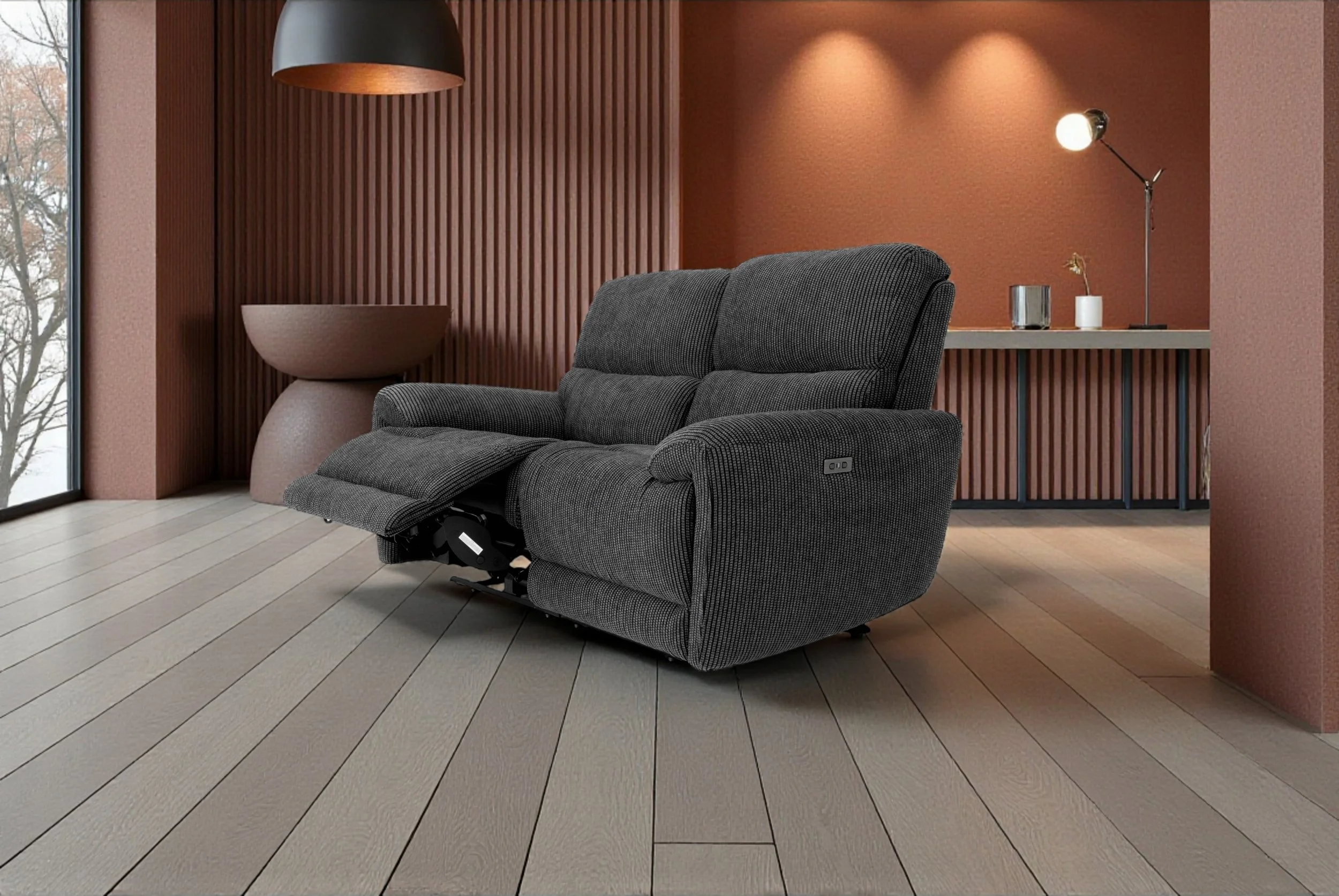 Black fabric sofa with visible reclining mechanisms beneath, isolated against a white background.