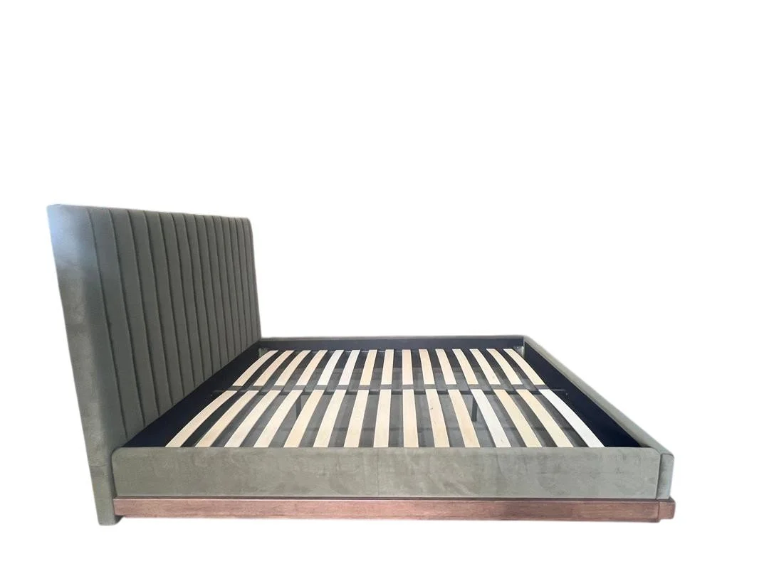Gray upholstered bed with slatted wooden support frame, no mattress, isolated on white background.