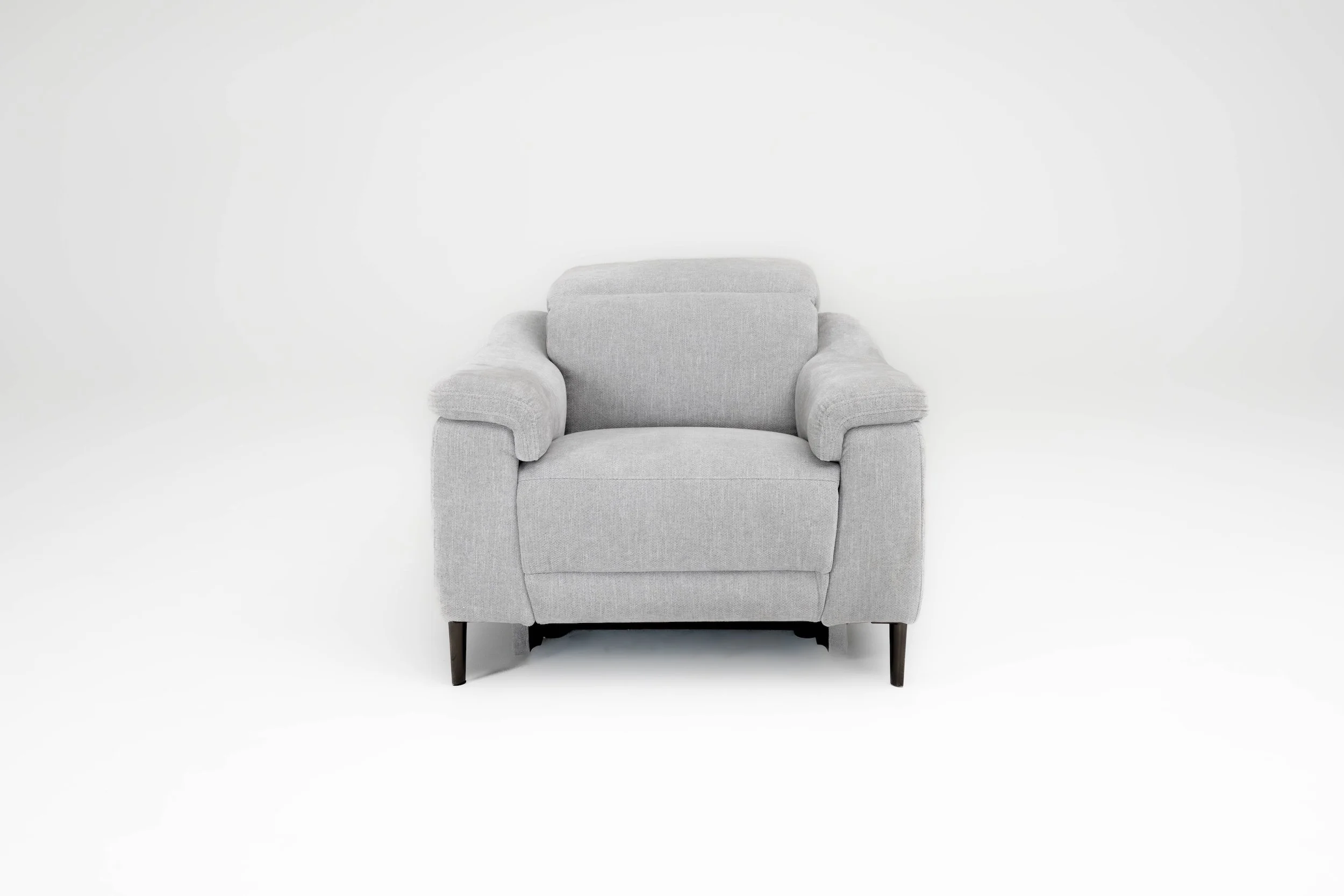 A light gray upholstered armchair with dark wooden legs against a white background.