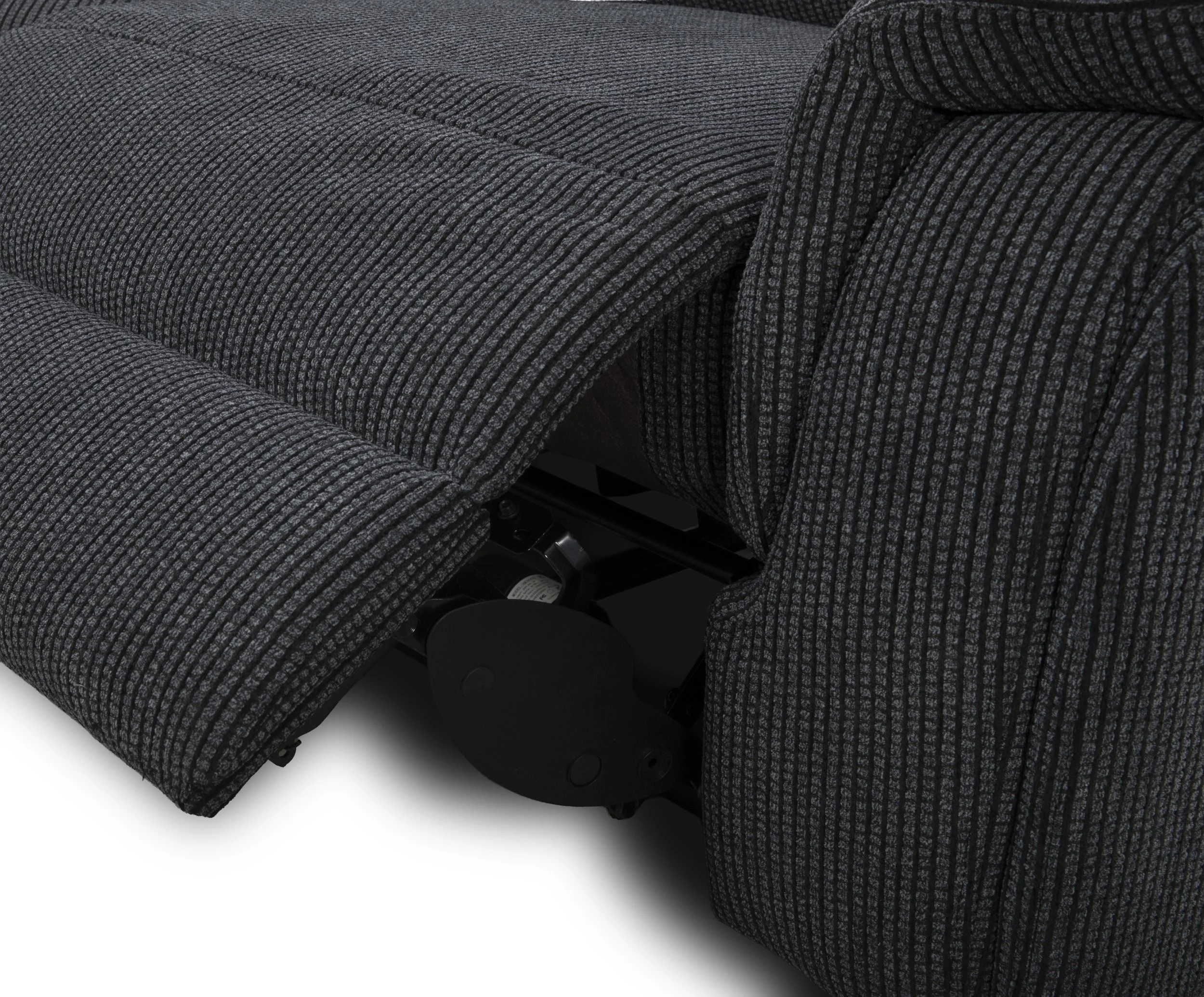 Close-up of a section of upholstered furniture with textured gray and black striped fabric, showing part of a concealed mechanism or wheel underneath.