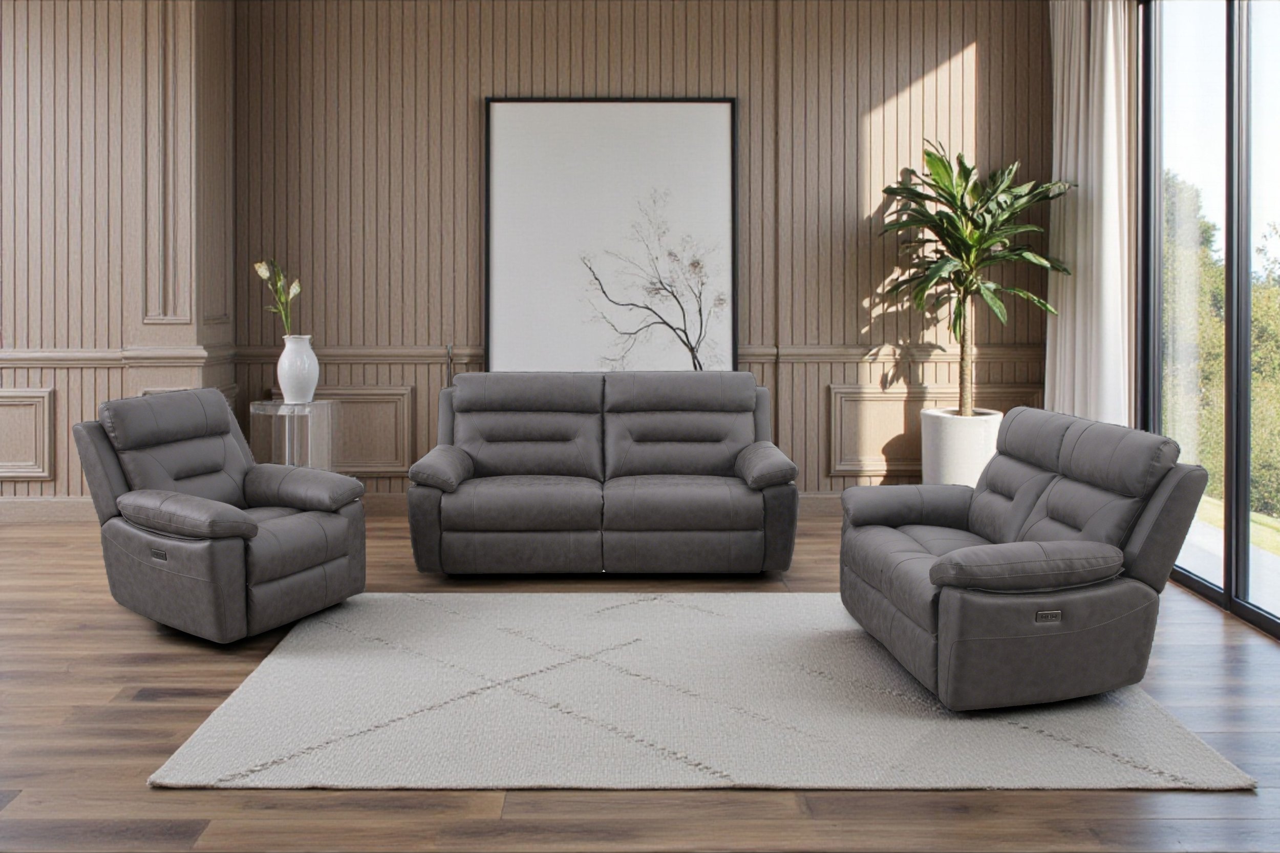 Set of three gray leather sofas, consisting of a two-seater sofa in the middle and two single-seat armchairs on each side, all with plush cushions and armrests.
