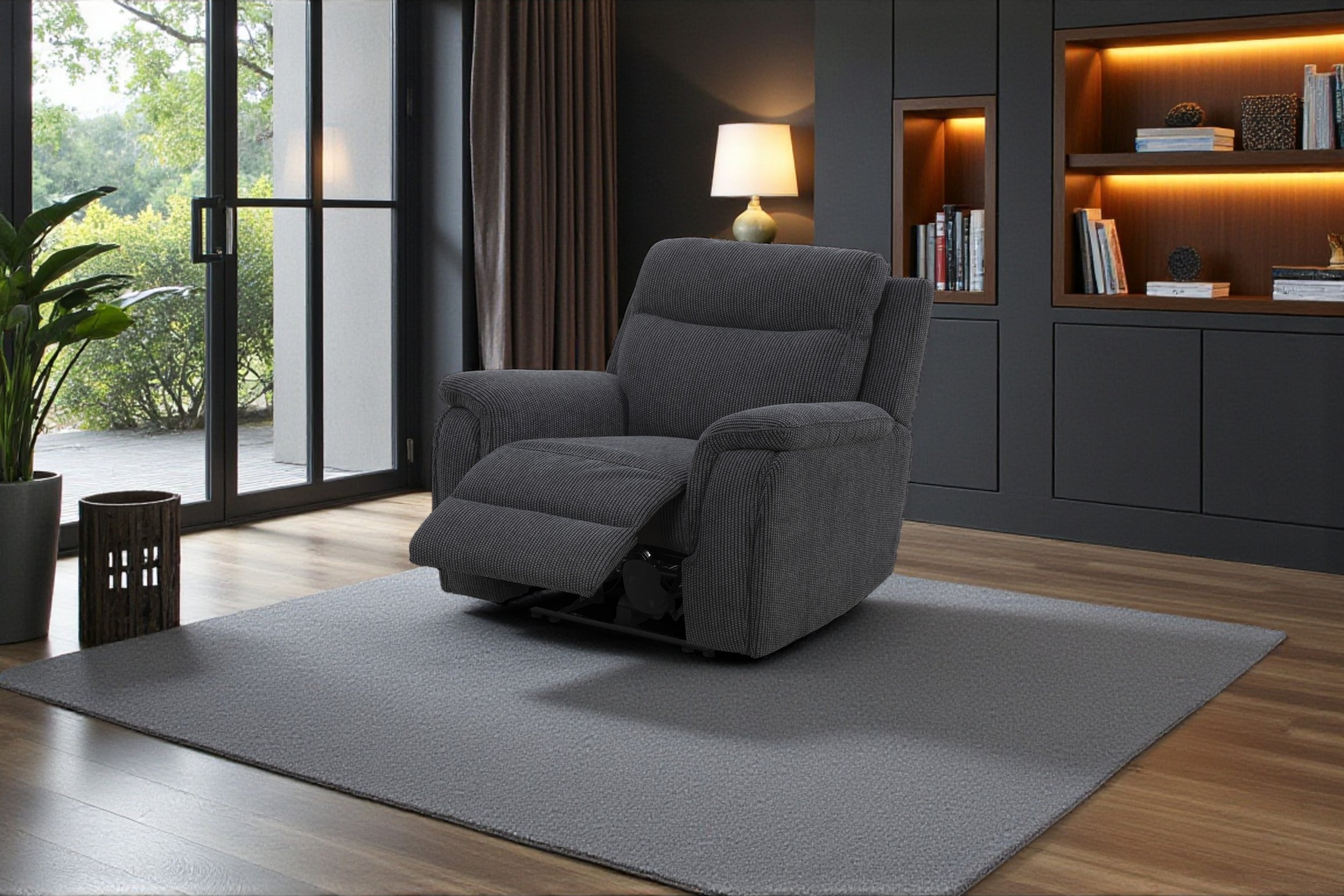 A cozy living room corner featuring a black armchair, a small round wooden coffee table with a large glass fishbowl and two glasses, a large potted plant with dried flowers, wooden parquet flooring, a beige area rug, a wood-paneled wall with modern black wall sconces, and an arched window with sheer white curtains showing a snowy outdoor scene.