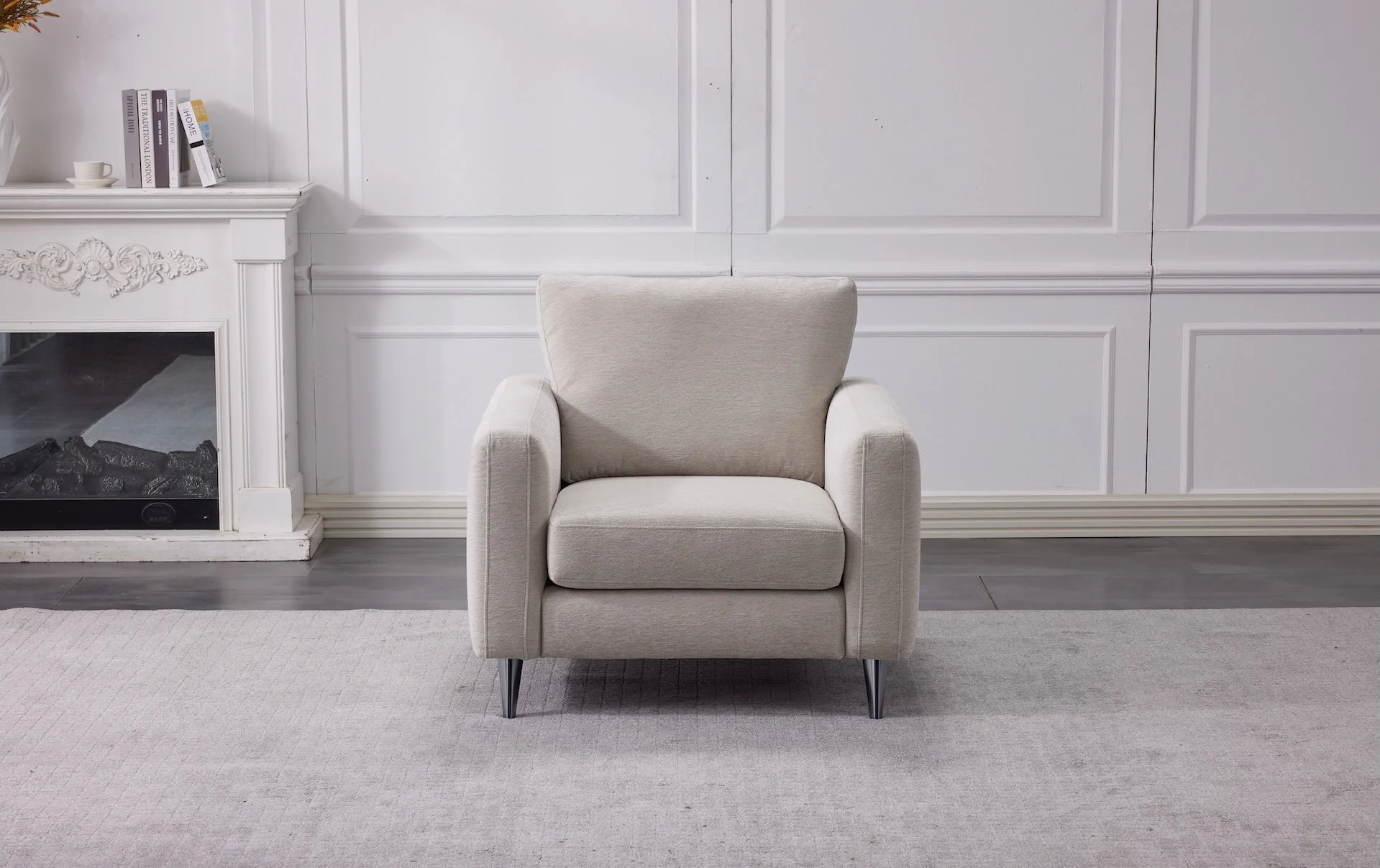A beige armchair in a room with white walls and a white fireplace mantel, on a light gray rug.