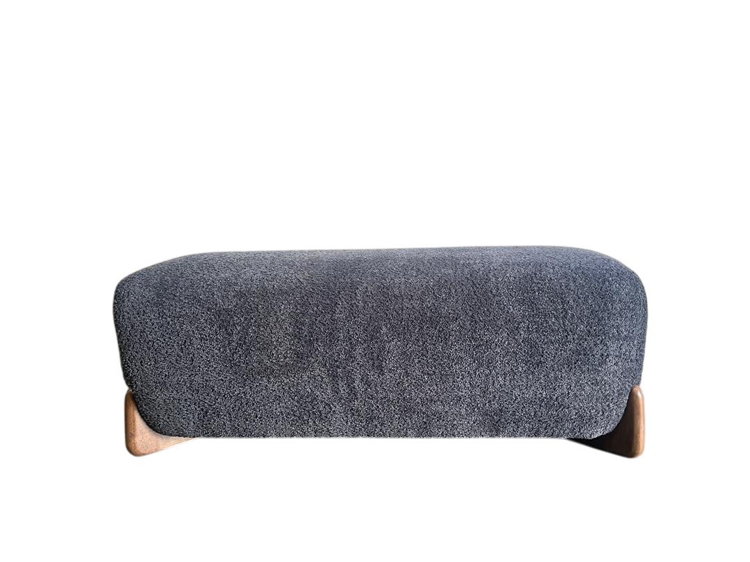 A modern, minimalist gray upholstered couch with wooden legs.