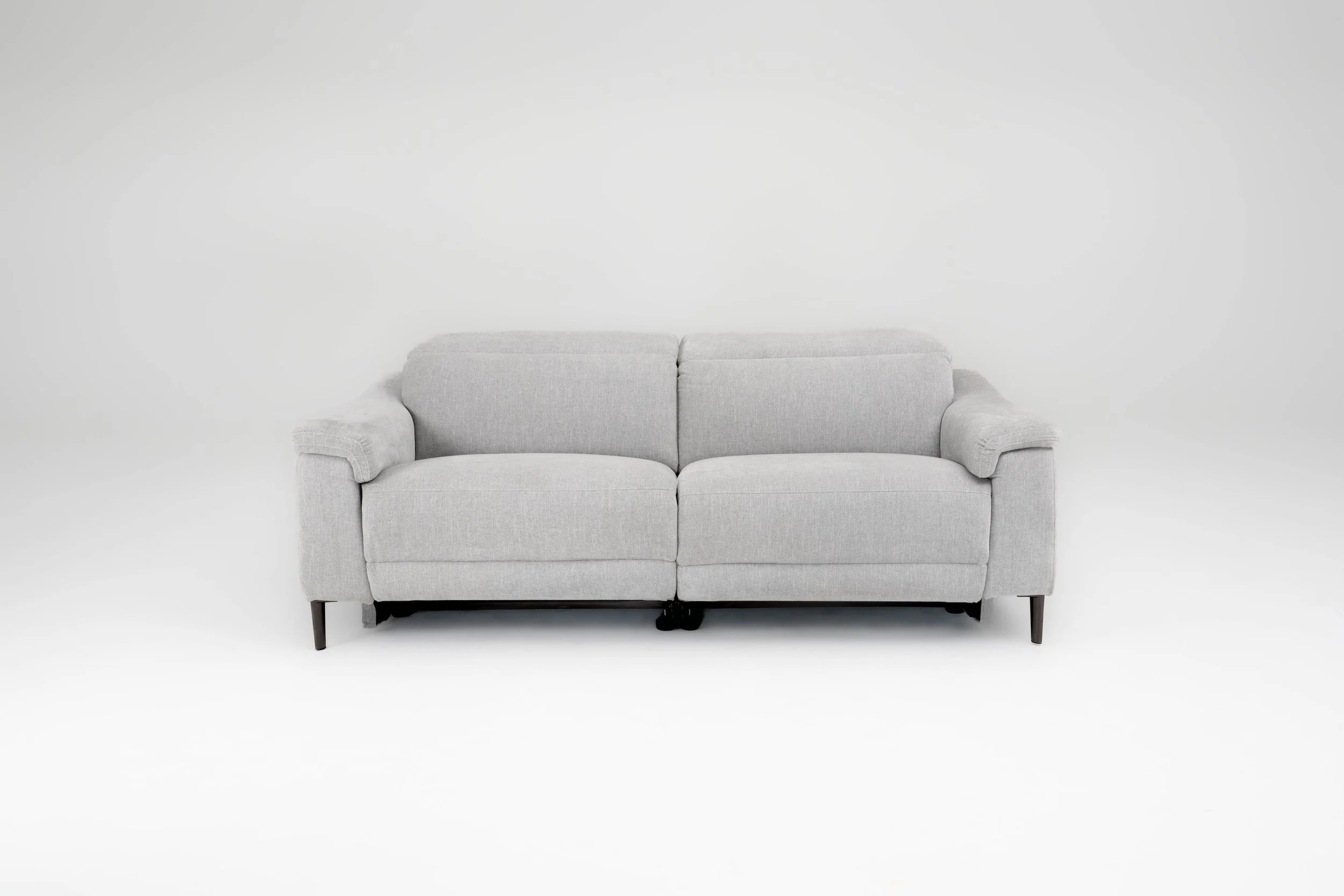 A light gray sofa with dark wooden legs set against a plain white background.