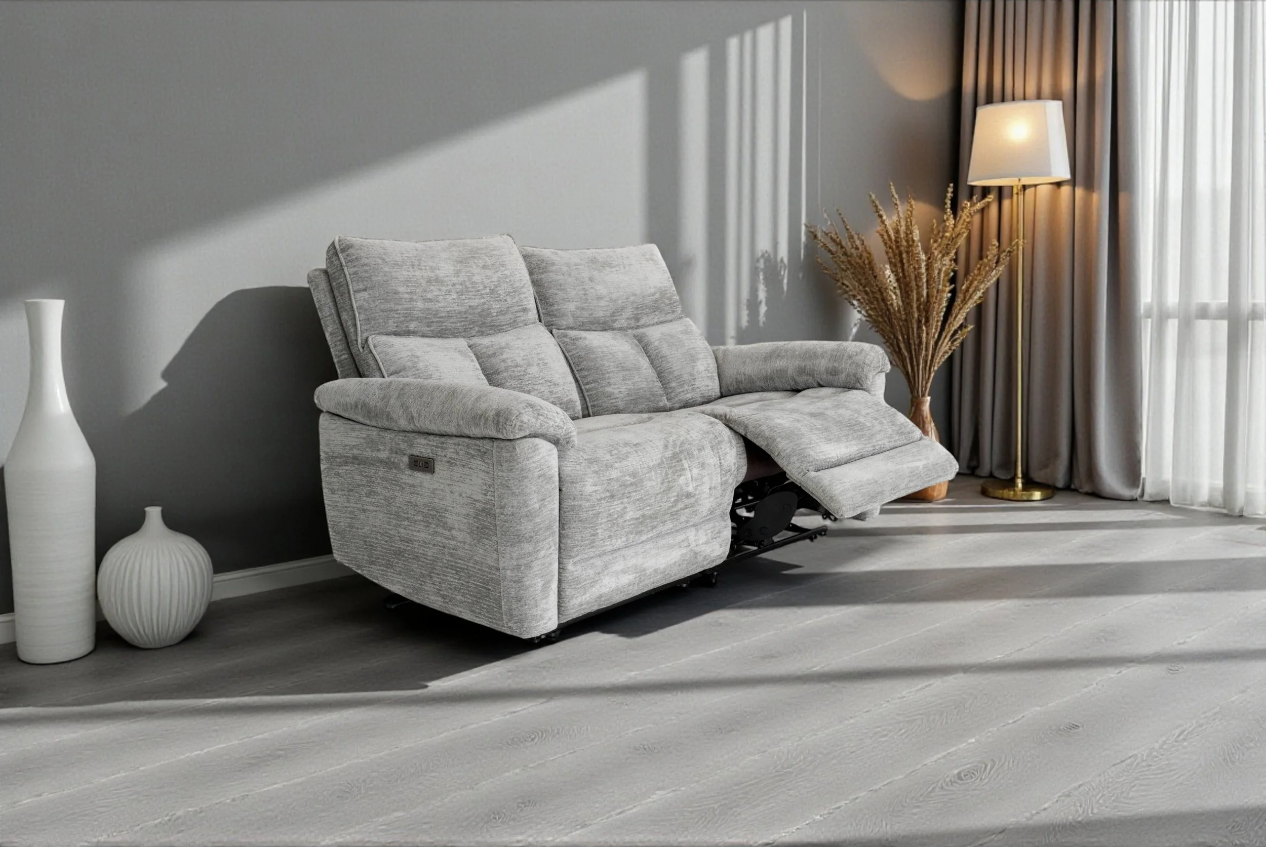 A gray fabric loveseat sofa with padded armrests, placed against a plain white background.