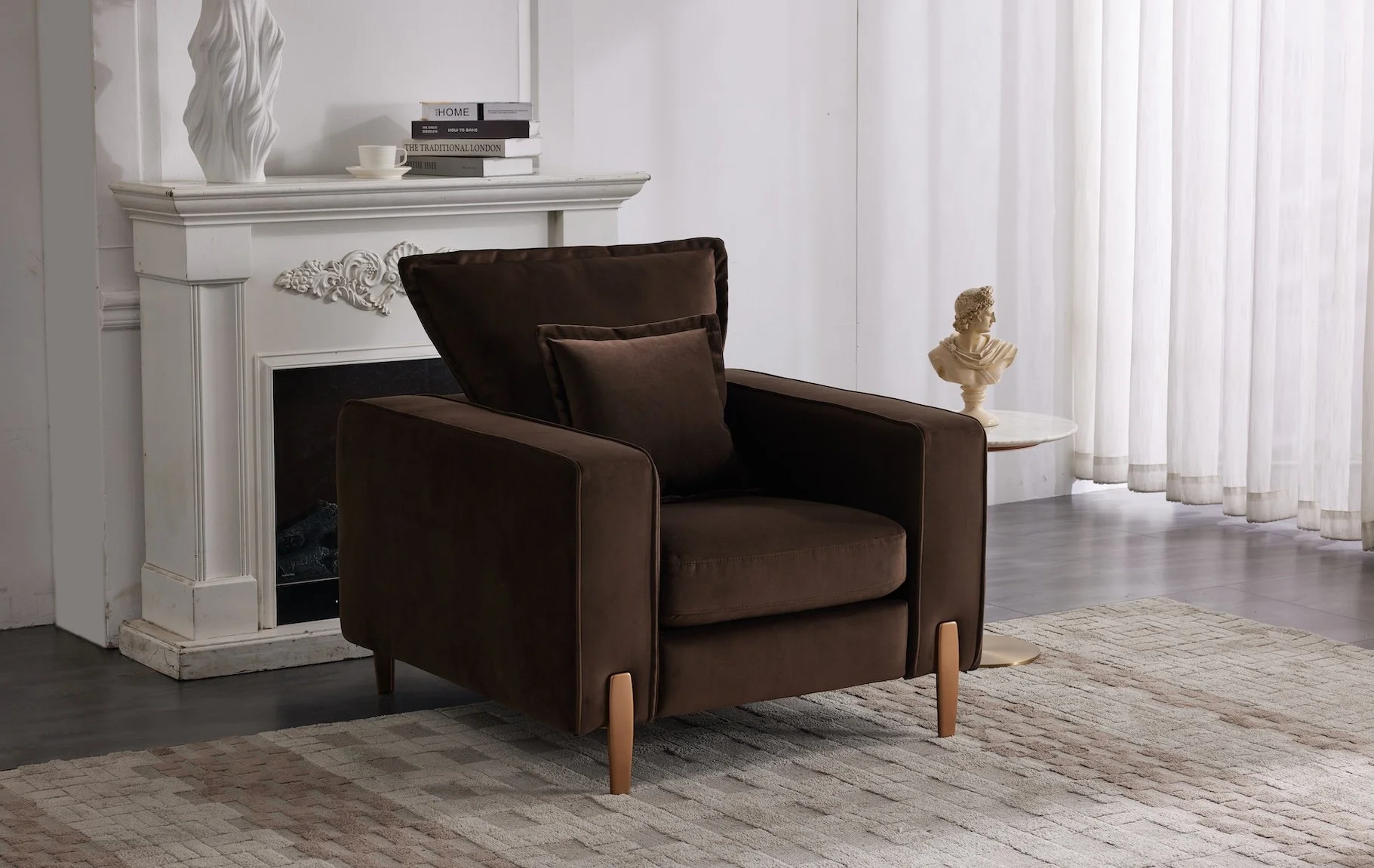A living room corner with a dark brown armchair, a black pillow, a small round side table with a bust sculpture, a white fireplace mantel with decor, and sheer white curtains.