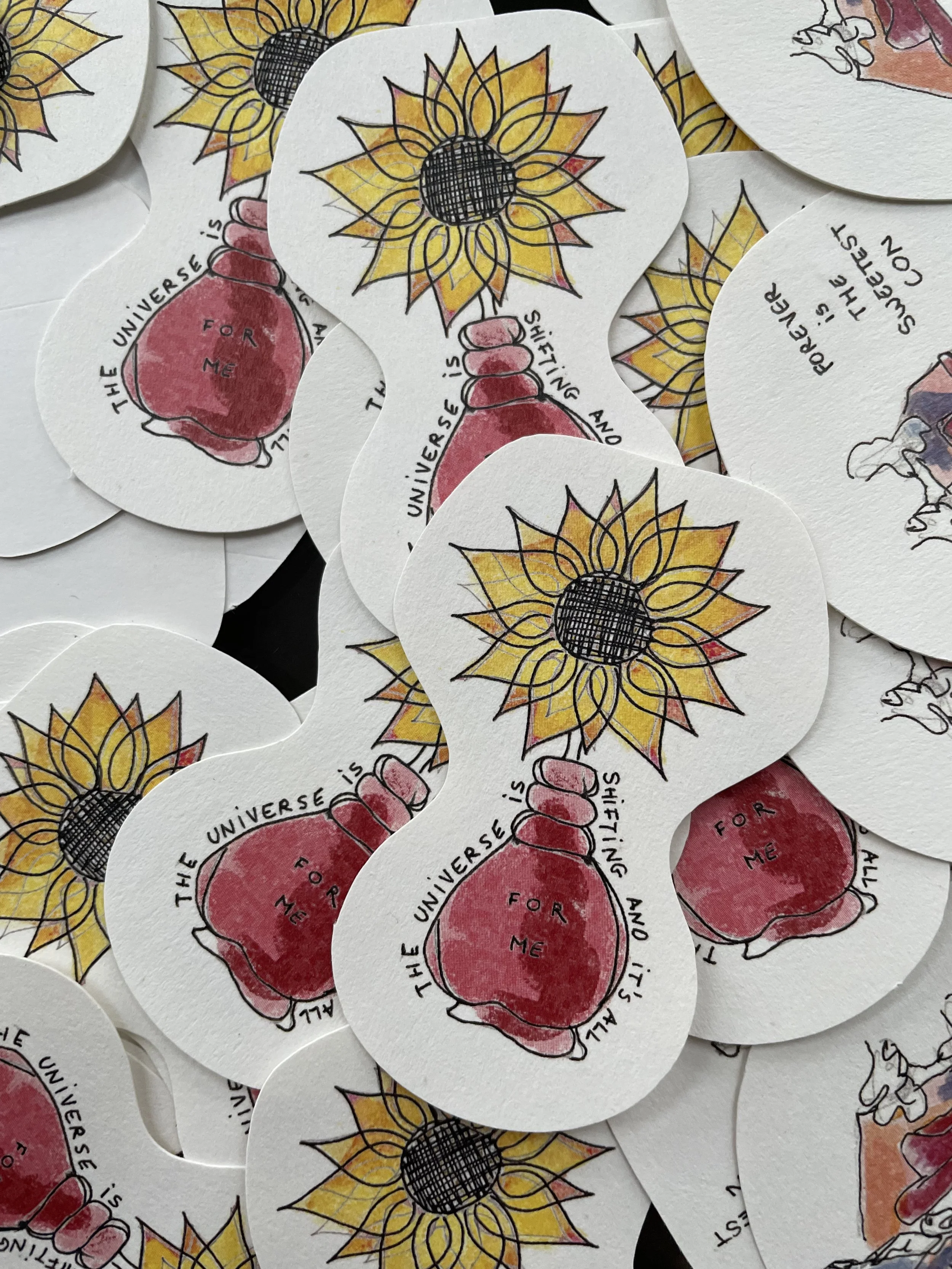 Collection of stickers with a drawing of a sunflower above a jar labeled 'For Me' and the phrase 'The universe is shining and it’s all for me' written around the jars.