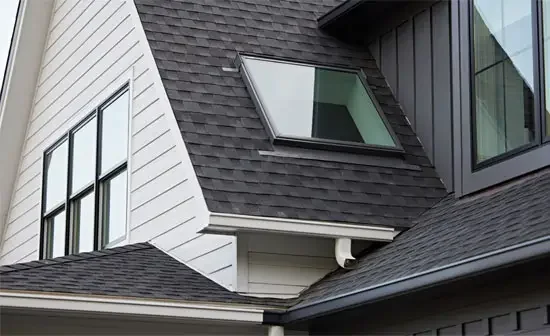 Close-up of a modern house roof with a skylight and windows