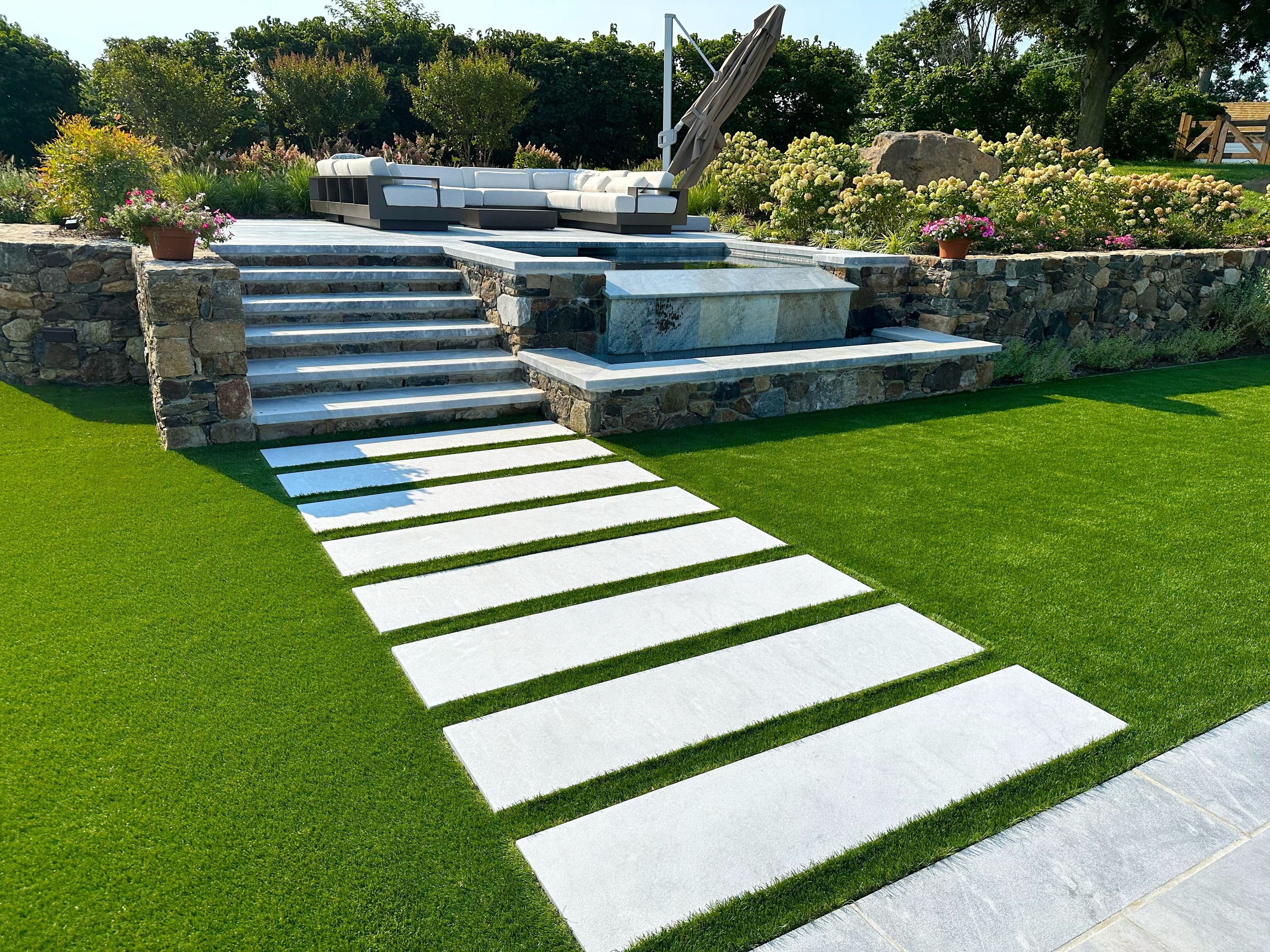 Expert hardscape installers completing a retaining wall project