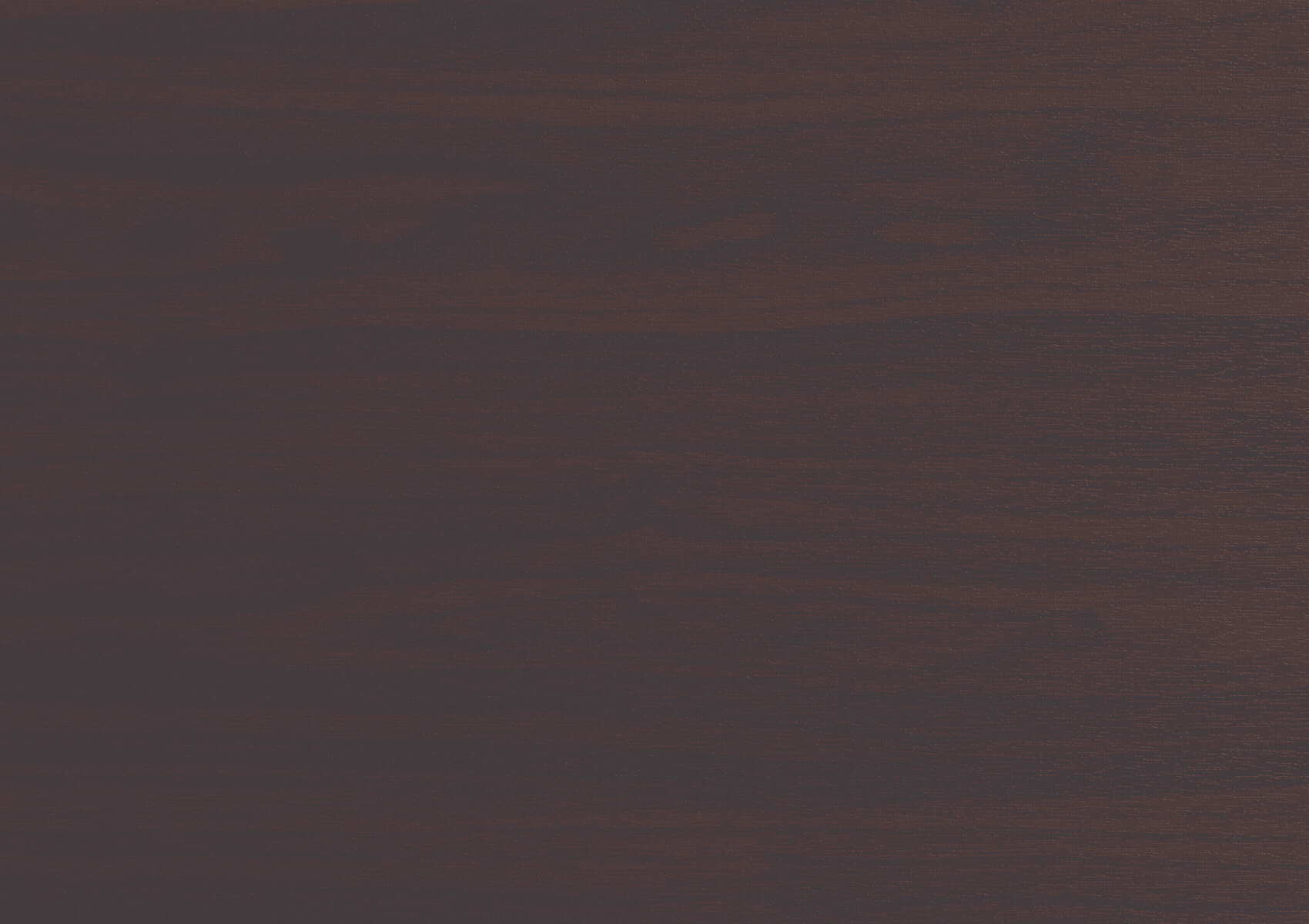 Close-up image of a dark wooden surface with visible grain and texture.