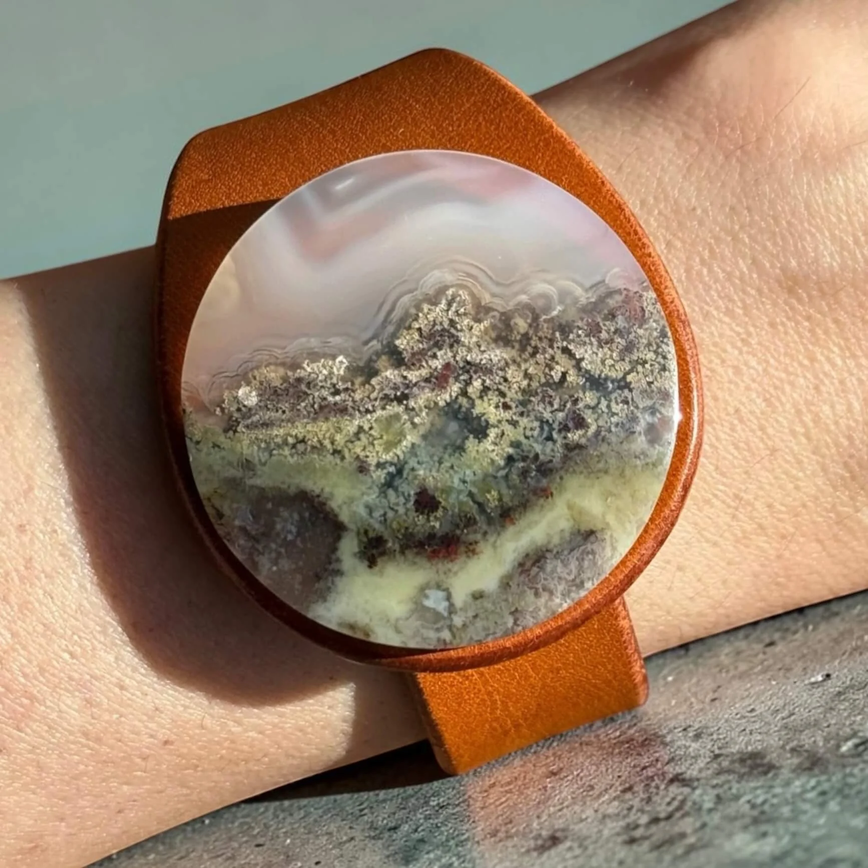 natural-scenic-moss-agate-tan-leather-bracelet-on-wrist.jpg