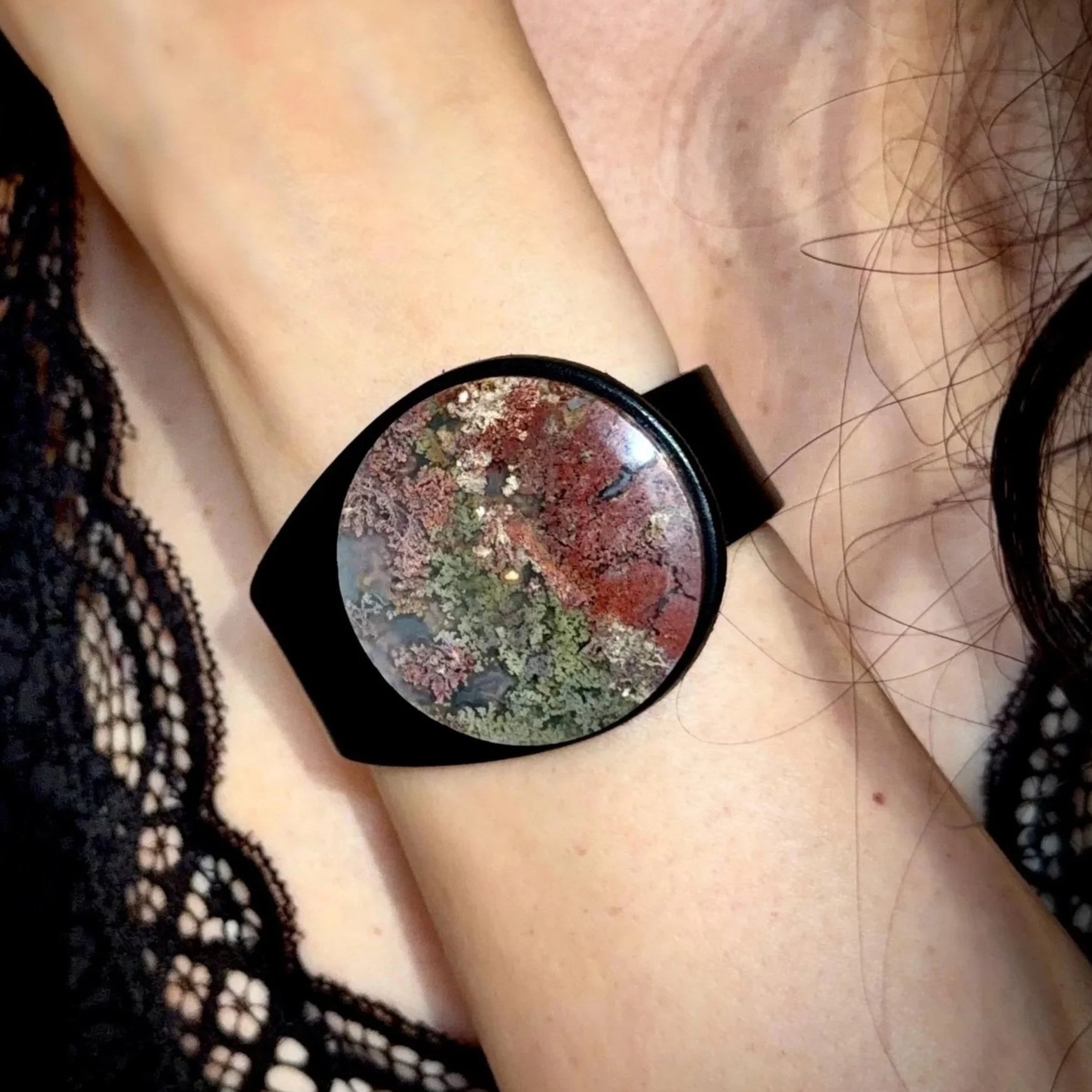 A woman wearing a Natural Moss Agate Gemstone & Leather Cuff