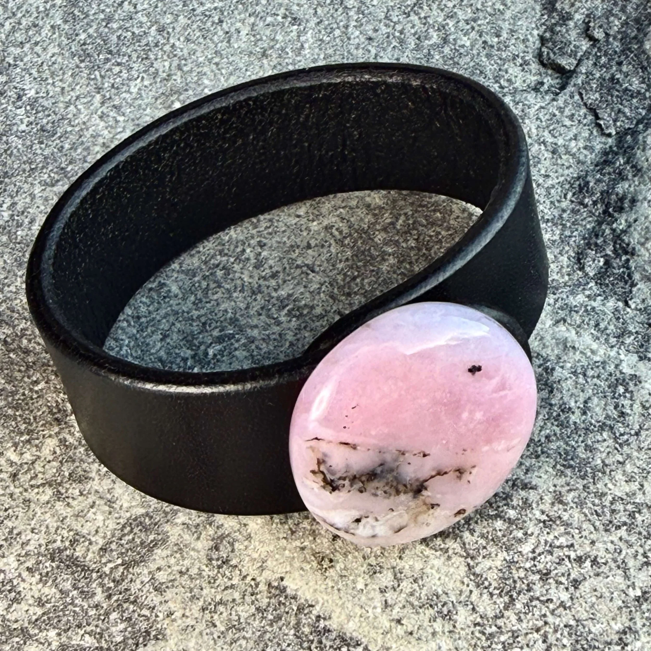 Natural-pink-opal-black-leather-bracelet-on-its-side.jpeg
