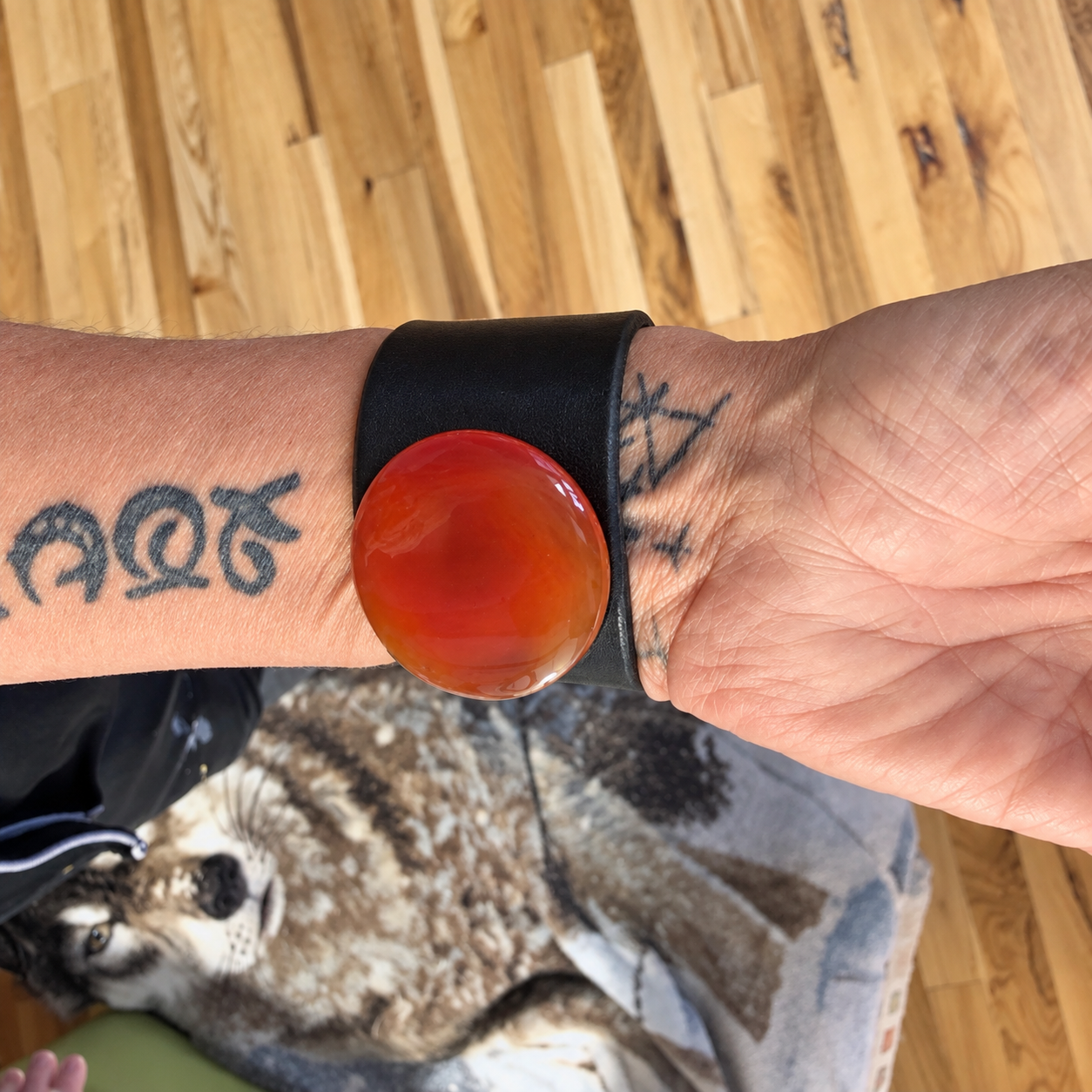 Womans wrist with leather and gemstone bracelet