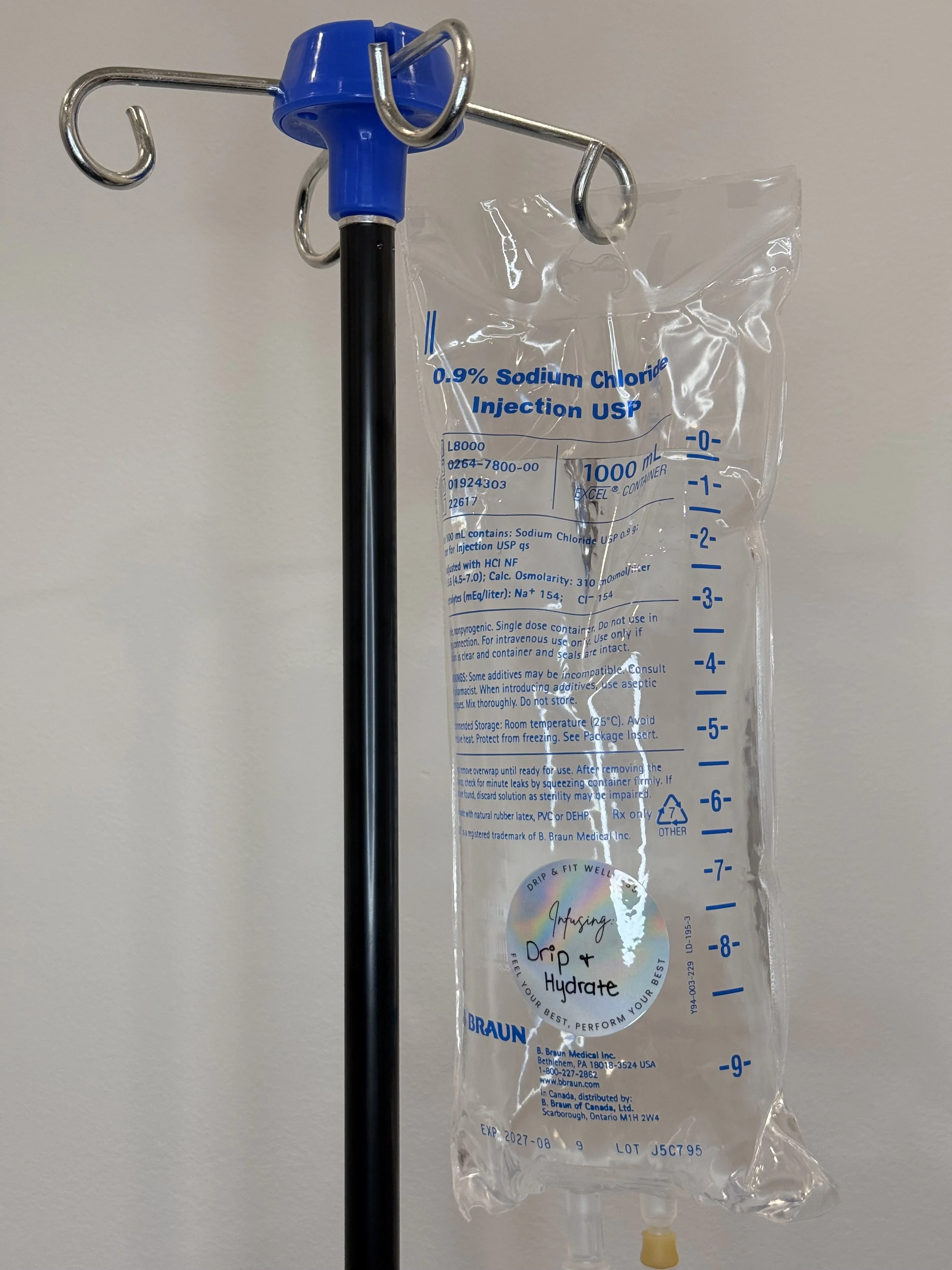 An IV drip bag filled with a solution labeled 0.9% Sodium Chloride Injection USP hanging from a stand.