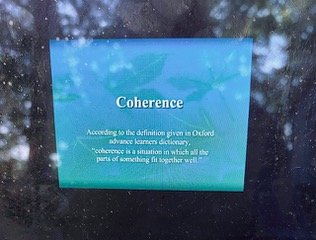 Digital screen displaying the word 'Coherence' with a definition about accordance in Oxford advanced learners dictionary.