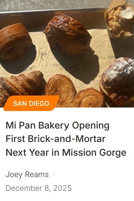 Assorted baked goods including croissants, muffins, and pastries on a tray.